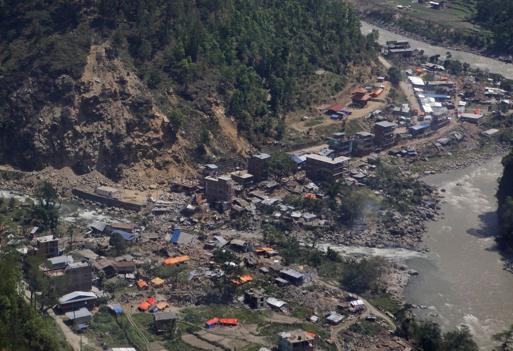 Damaged houses are seen from a helicopter at Charikot, Nepal, Thursday, May 14, 2015. Nepal has been overwhelmed by its second massive earthquake in less than three weeks, its prime minister said Thursday as he visited this normally placid foothills town, now a center for frightened villagers desperate for government help. (AP Photo/Niranjan Shrestha)