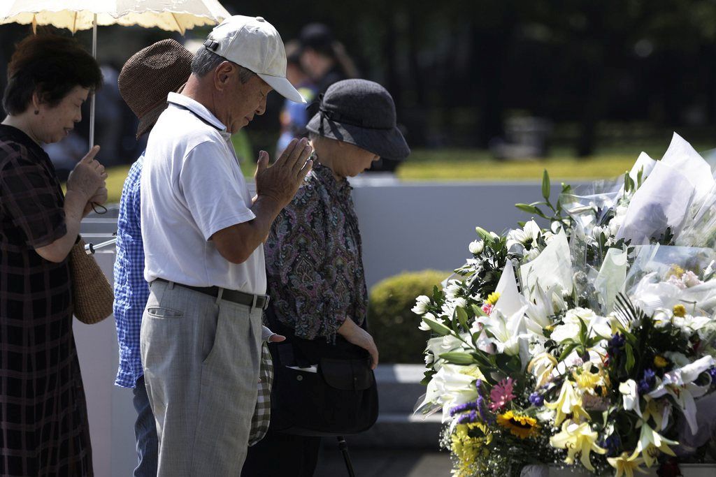 epa04872458 People offer prayers for victims killed by the atomic bombing during World War II in 1945, in front of a cenotaph at Hiroshima Peace Memorial Park in Hiroshima, western Japan, 05 August 2015. Hiroshima will mark the 70th anniversary of the world's first nuclear bombing of the city on 06 August 2015. A nuclear bomb codenamed 'Little Boy' was dropped on Hiroshima on 06 August 1945, killing tens of thousands of people in seconds. By the end of the year, 140,000 people had died from the effects of the bomb. The 'Little Boy' was the first ever nuclear bomb dropped on a city and a crucial turn that led to Japan's surrender in WWII.  EPA/KIYOSHI OTA