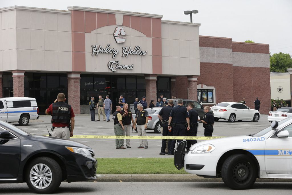 Police work outside a movie theater complex where officials reported a man with at least one gun and a weapon described as a hatchet was killed by police on Wednesday, Aug. 5, 2015, in Antioch, Tenn. (AP Photo/Mark Humphrey)