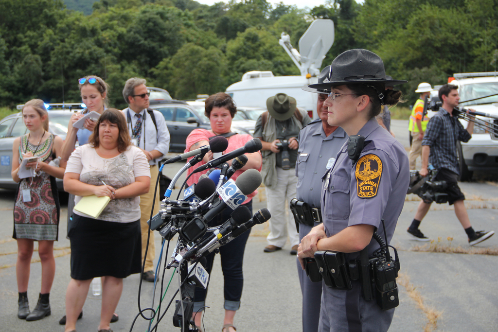 Virginia State Trooper Pamela Neff, answers questions from reporters about identifying suspect Vester Lee Flanagan's car at the intersection of I-81 and I-66, in Markham, Va., Wednesday, Aug. 26, 2015, after following him on I-66 to where he was found suffering a self-inflicted gunshot wound. (AP Photo/David Bruns).
