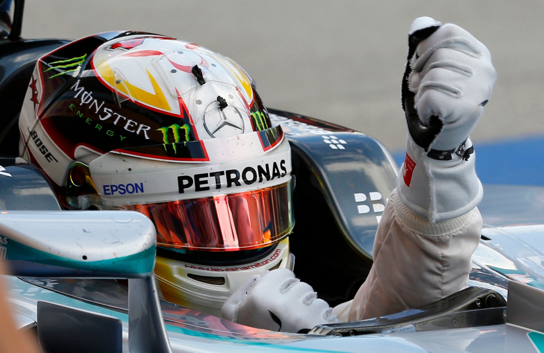 Mercedes driver Lewis Hamilton of Britain celebrates in his car at the parc ferme after winning the Japanese Formula One Grand Prix at the Suzuka Circuit in Suzuka, central Japan, Sunday, Sept. 27, 2015 (AP Photo/Shizuo Kambayashi) Japan F1 GP Auto Racing