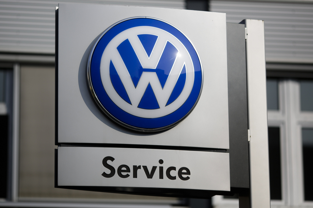 The VW sign of Germany's car company Volkswagen is displayed at the building of a compsny's retailer in, Berlin, Germany, Monday, Oct. 5, 2015. (AP Photo/Markus Schreiber)