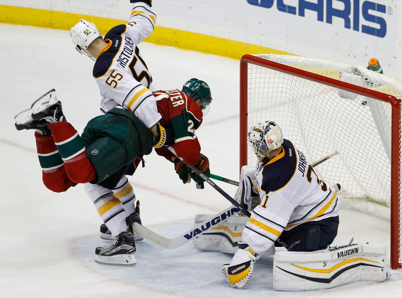 Buffalo Sabres defenseman Rasmus Ristolainen (55), of Finland, holds Minnesota Wild right wing Nino Niederreiter, of Switzerland, after a shot by Niederreiter went wide past Sabres goalie Chad Johnson, right during a test of 3-on-3 overtime play after an NHL preseason hockey game in St. Paul, Minn., Thursday, Oct. 1, 2015. The Wild won 6-1. (AP Photo/Ann Heisenfelt) Sabres Wild Hockey