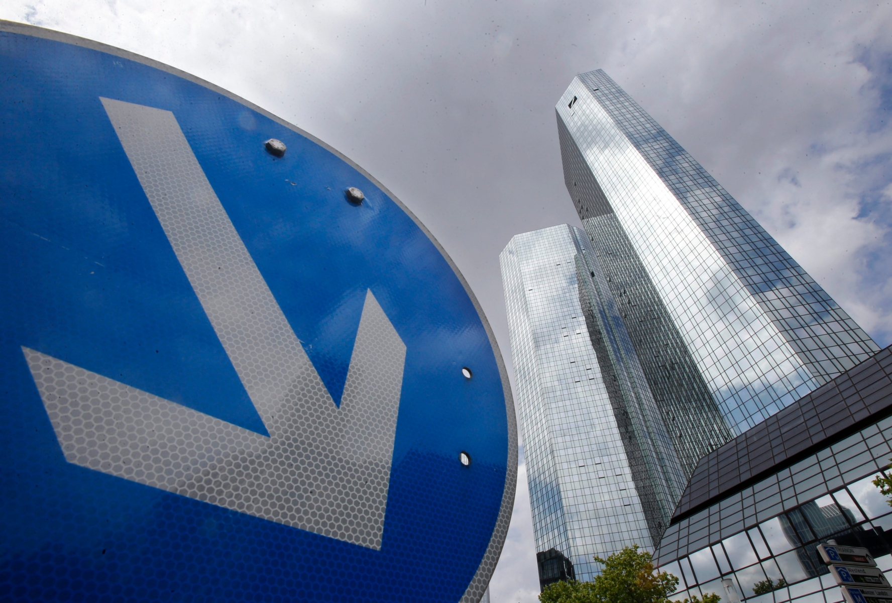 FILE - In this June 9, 2015 file photo the headquarters of Deutsche Bank is photographed in Frankfurt, Germany. In an unscheduled statement late Wednesday, Oct. 7, 2015 Germanys biggest bank said it expects to report a third-quarter net loss of 6.2 billion euros (US dollar 7 billion) because of a combination of write-downs and litigation costs. (AP Photo/Michael Probst, file) Germany Deutsche Bank