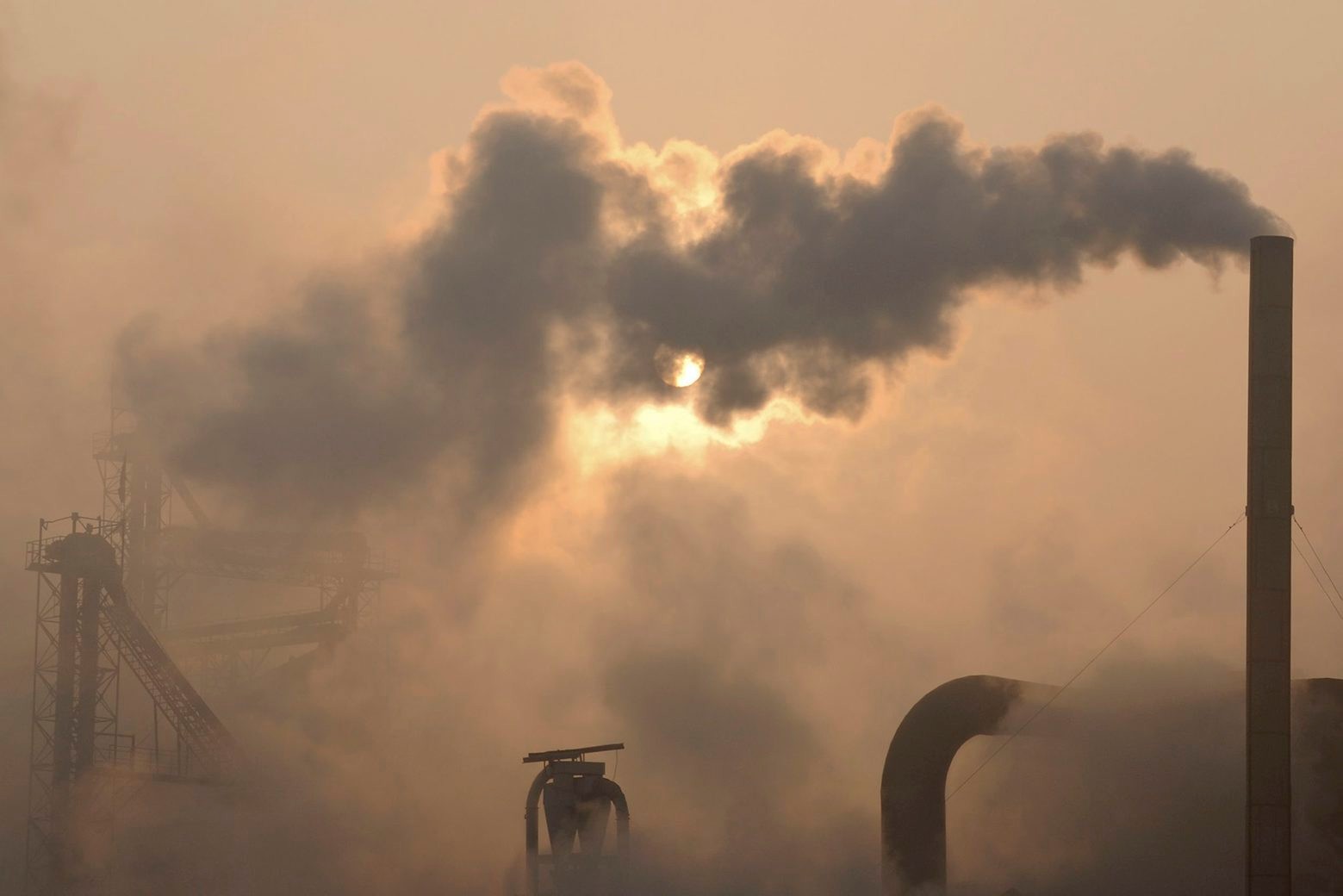 Smoke is emitted from chimneys of a cement plant in Binzhou city, in eastern China's Shandong province on Thursday, Jan. 17, 2013. China, the world's largest producer of carbon dioxide, is directly feeling the man-made heat of global warming, scientists conclude in the first study to link the burning of fossil fuels to one country's rise in its daily temperature spikes. The study appeared online in late March 2013 in the peer reviewed journal Geophysical Research Letters. (AP Photo)  CHINA OUT China Changing Temperatures