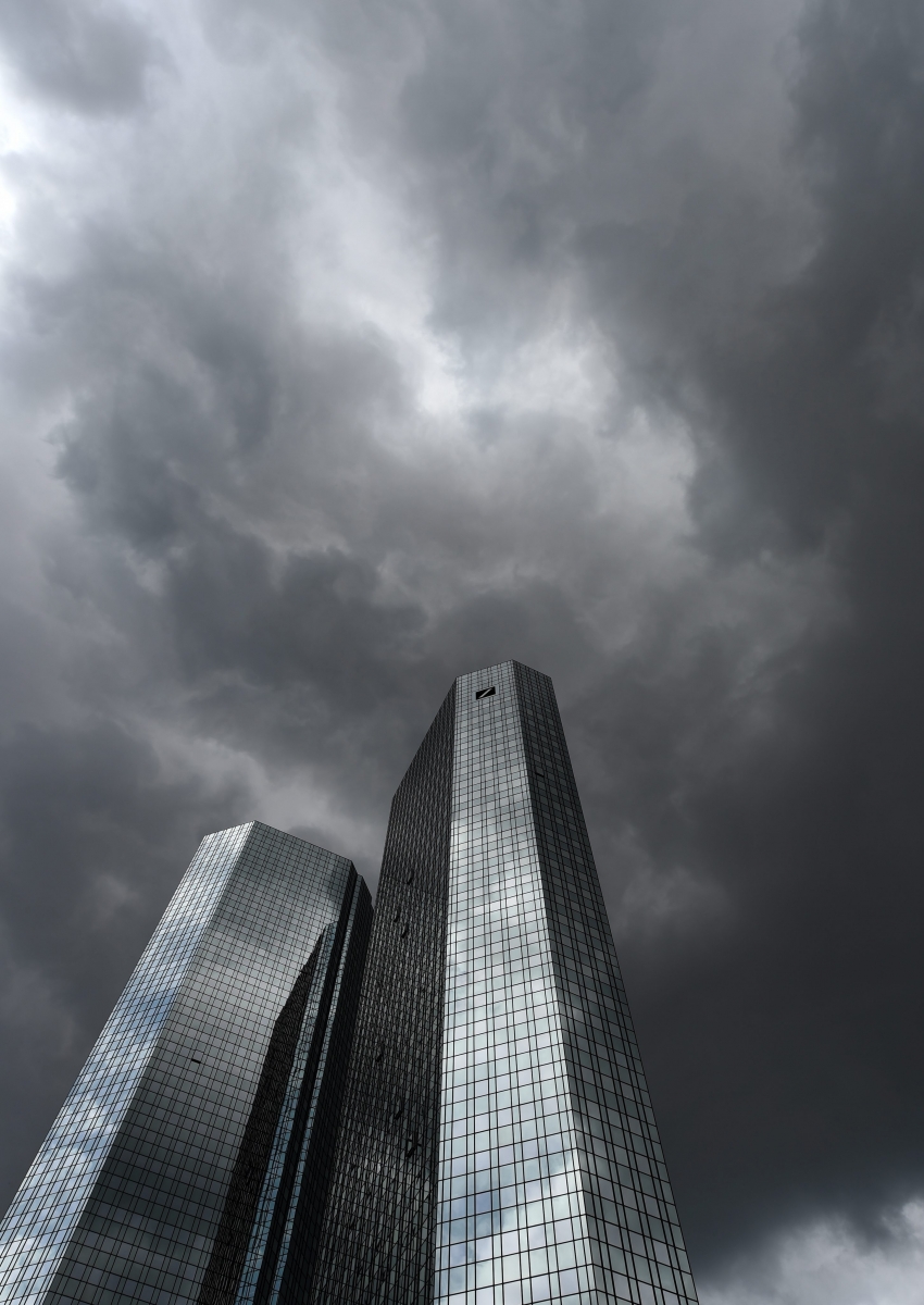 epa05001596 (FILE) A file photo dated 20 May 2015 showing dark clouds hovering over the headquarters of German banking and financial services corporation Deutsche Bank in Frankfurt, Germany. Deutsche Bank, Germany's largest bank, said 29 October 2015 that it will cut about 9,000 jobs, four days after it announced a restructuring. The reorganization of the bank's leadership was announced Sunday by chief executive John Cryan, who said the aim was 'to create a bank that's better-controlled, more cost-efficient and more strongly focused.' The bank has been dogged by a host of problems in recent months, ranging from shake-ups in management to major anticipated losses. It also was fined 2.5 billion dollars in April for its role in manipulating the benchmark Libor interest rate, which banks charge one another for loans. Deutsche Bank is also preparing to sell its Postbank subsidiary, which will mean a loss of a further 15,000 positions.  EPA/ARNE DEDERT FILE GERMANY ECONOMY DEUTSCHE BANK