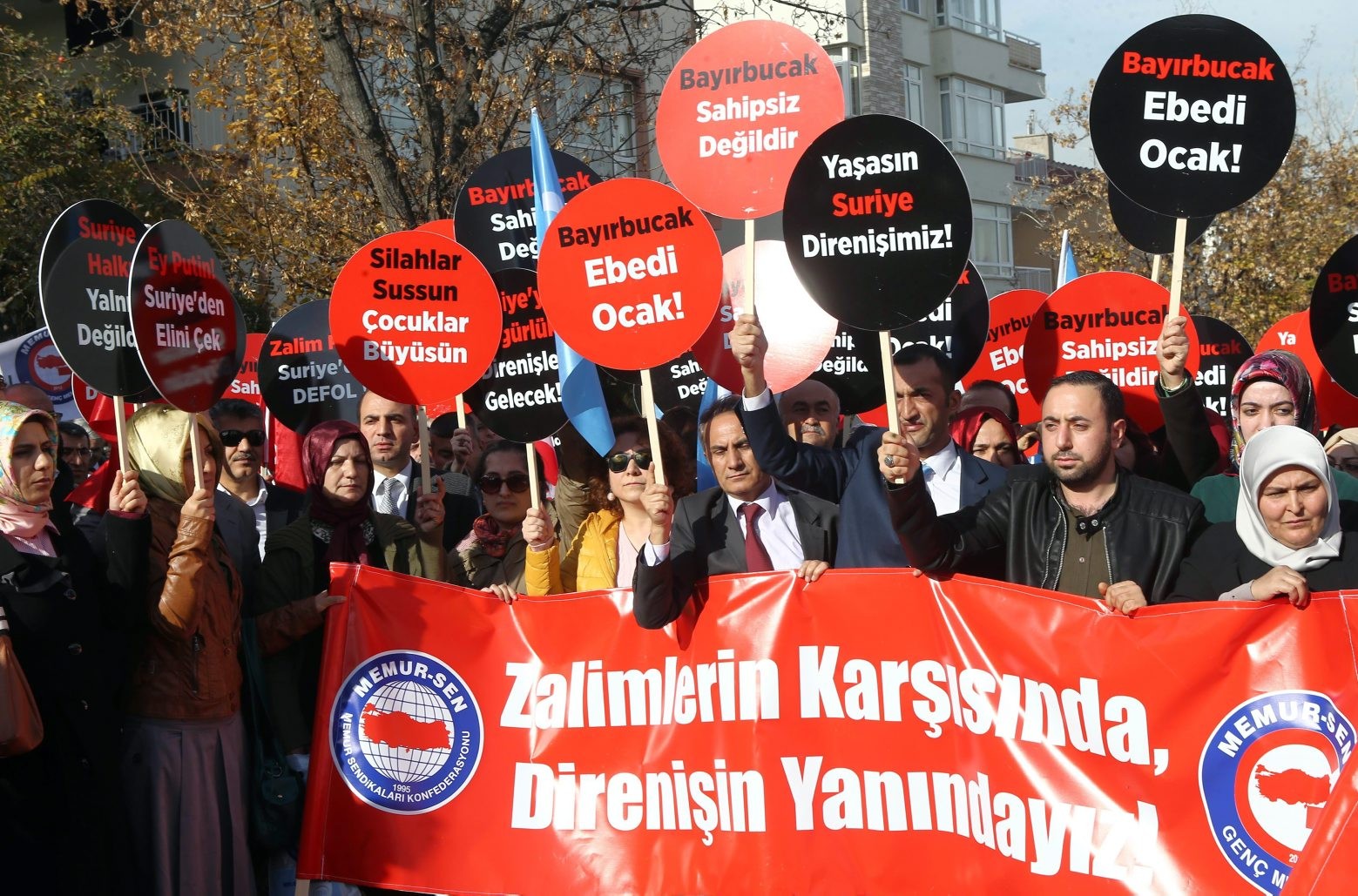 Turkish demonstrators hold a banner and placards that read " we are with resistance against aggressors" as they protest Russian support to Assad regime in Syria, outside the Russian embassy in Ankara, Turkey, Tuesday, Nov. 24, 2015. Turkey shot down a Russian warplane Tuesday, claiming it had violated Turkish airspace and ignored repeated warnings. Russia denied that the plane crossed the Syrian border into Turkish skies. Russia said the Su-24 was downed by artillery fire, but Turkey claimed that its F-16s fired on the Russian plane after it ignored several warnings.(AP Photo) Turkey Syria Plane