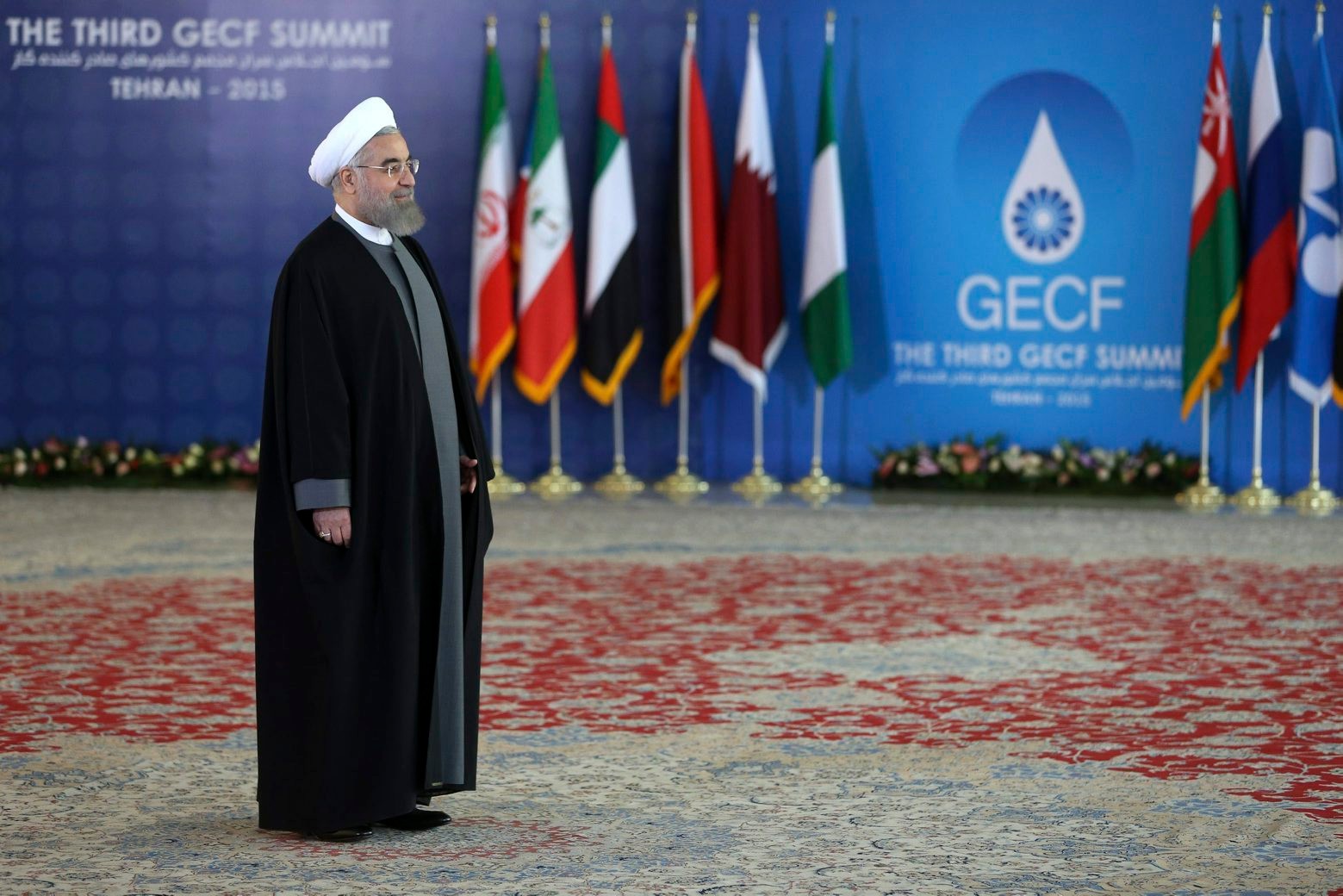 Iranian President Hassan Rouhani stands while waiting to welcome leaders of Gas Exporting Countries Forum, GECF, to attend their third summit in Tehran, Iran, Monday, Nov. 23, 2015. (AP Photo/Ebrahim Noroozi) Mideast Iran GECF Summit