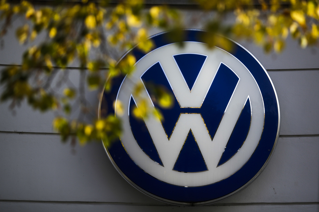 In this Oct. 5, 2015 file photo the VW sign of Germany's car company Volkswagen is displayed at the building of a company's retailer in, Berlin, Germany. Volkswagen is telling employees that they can come forward with information about how the company cheated on emissions tests  and won't be fired. (AP Photo/Markus Schreiber, file)