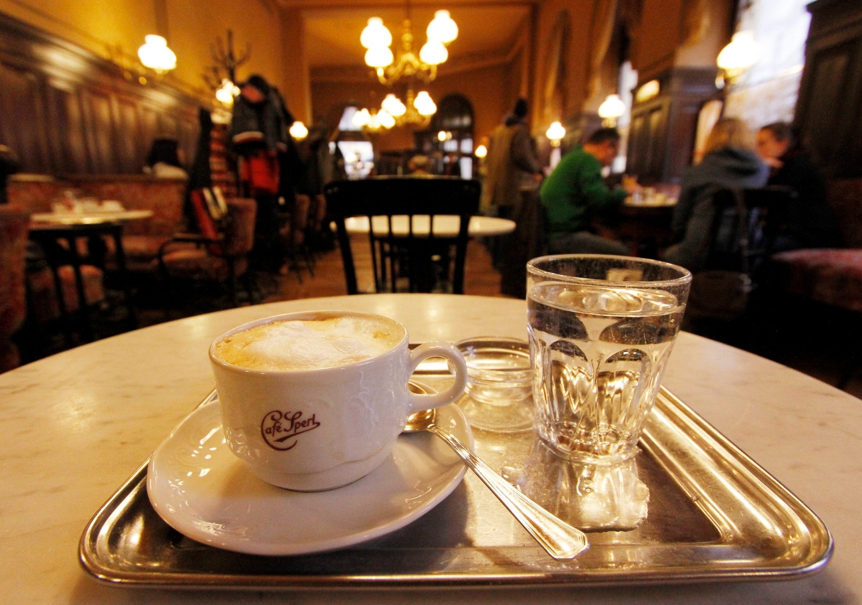FILE - In this Nov. 16, 2011 file photo a cup of coffee with a glass of water stands on a table at a cafe in Vienna, Austria. The Viennese take it for granted but elsewhere it is rapidly becoming a rare commodity: crystal-clear water drunk straight from the tap. Vienna gets its water supply from alpine springs, some fed by glaciers, transported for over 100 miles without the aid of pumps or other mechanical means. A glass of free Vienna water comes without asking with your cup of Viennese coffee, at least in most establishments. (AP Photo/Ronald Zak, File) Travel Trip 5 Free Things Vienna