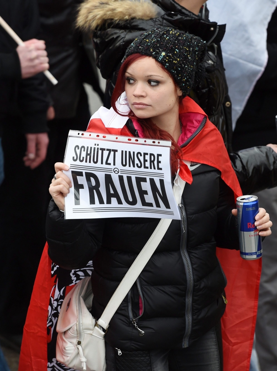 epa05094088 A protester holds a sign that reads 'Schuetzt unsere Frauen' (lit. protect our women) at a demonstration against German asylum policy in Freilassing, Germany, 09 January 2016. The right-wing alliance 'Wir sind die Grenze' (lit. we are the border) called a demonstration in the border town and opposes the German government's refugee policy.  Chancellor Angela Merkel said on 09 January 2016 that she wants stricter asylum laws, after a series of sexual assaults in the western German city of Cologne shocked the country. 'What happened on New Year's Eve are despicable criminal acts that demand decisive answers,'  Merkel said after a meeting among the top ranks of her Christian Democratic Union.  EPA/TOBIAS HASE GERMANY MIGRANTS REFUGEES CRISIS