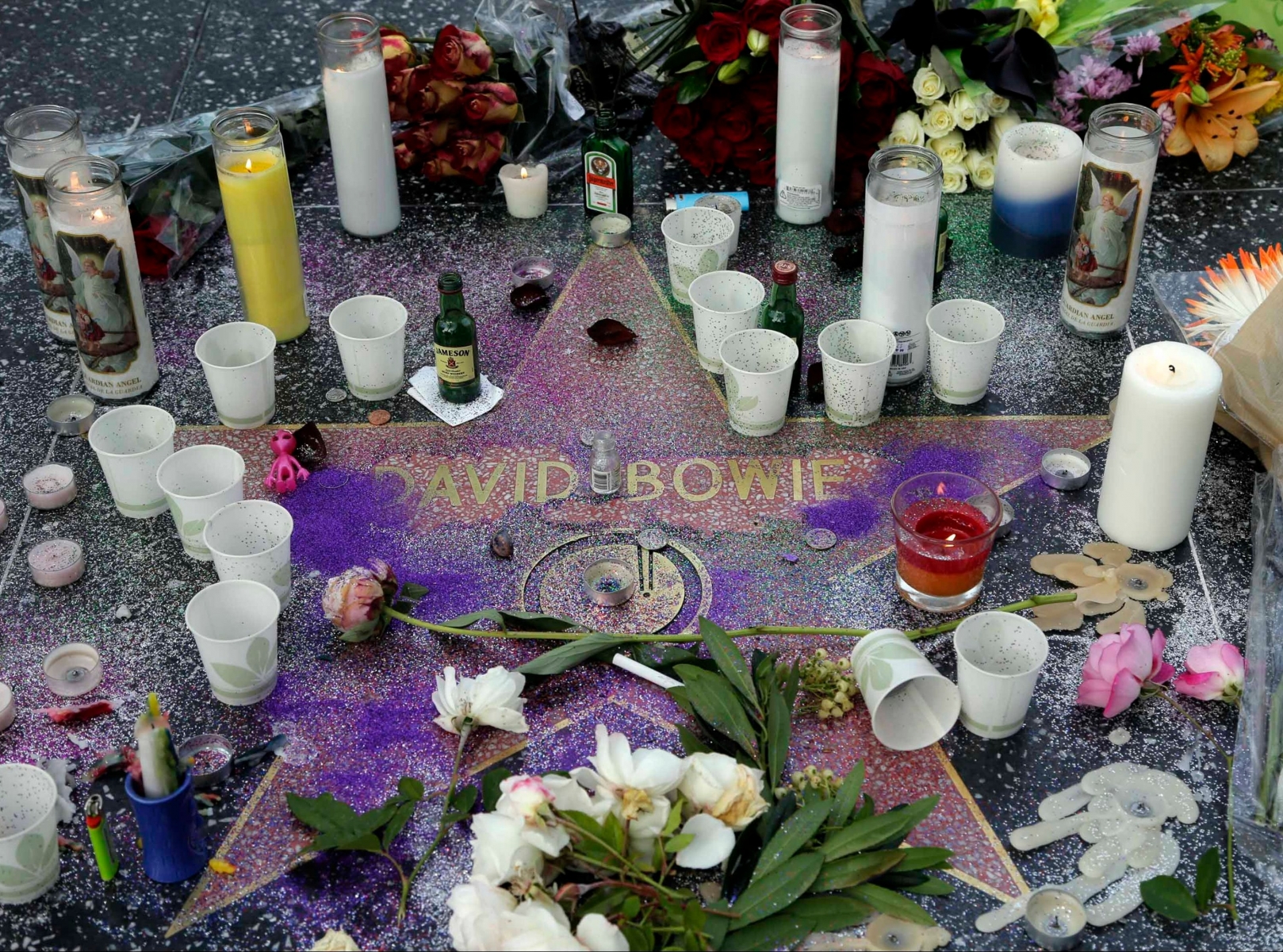 A makeshift memorial surrounds David Bowie's star on the Hollywood Walk of Fame in Los Angeles, Monday, Jan. 11, 2016. Bowie, the other-worldly musician who broke pop and rock boundaries with his creative musicianship, nonconformity, striking visuals and a genre-spanning persona he christened Ziggy Stardust, died of cancer Sunday. He was 69 and had just released a new album. (AP Photo/Nick Ut) Obit David Bowie