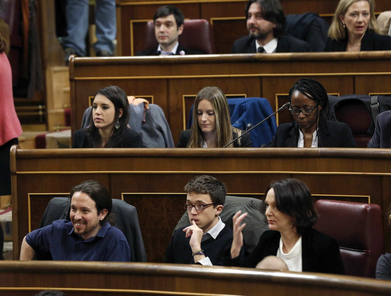 epa05099748 Podemos party MPs (L-R, first row) Pablo Iglesias, Inigo Errejon, Carolina Bescansa (L-R, second row) Irene Montero, Angela Ballester, Rita Bosaho (L-R, third row) Pablo Bunstinduy, Rafael Mayoral and Victoria Rosell attend the formation session of the Lower Chamber in Madrid, Spain, 13 January 2016. The Spanish Parliament celebrated the opening of the 11th term of office of the country's Democracy. Spanish socialist party and Ciudadanos party agreed the previous day to choose the election of socialist MP Patxi Lopez as the President of the Lower Chamber, while the People's Party has decided not to present a candidate as a step forward to a future agreement with the socialist party towards a coalition to avoid new general elections.  EPA/SERGIO BARRENECHEA SPAIN GOVERNMENT