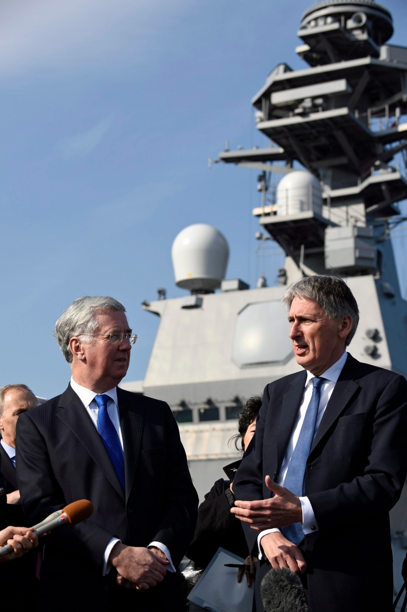 epa05092192 British Foreign Secretary Philip Hammond (R) speaks to reporters next to Defense Secretary Michael Fallon during their visit of Japanese Maritime Self-Defense Force's (JMSDF) helicopter carrier Izumo at Yokosuka Naval Base in Yokosuka, near Tokyo, Japan, 08 January 2016. Hammond and Fallon are in Japan to meet their Japanese couterparts.  EPA/FRANCK ROBICHON JAPAN BRITAIN DIPLOMACY