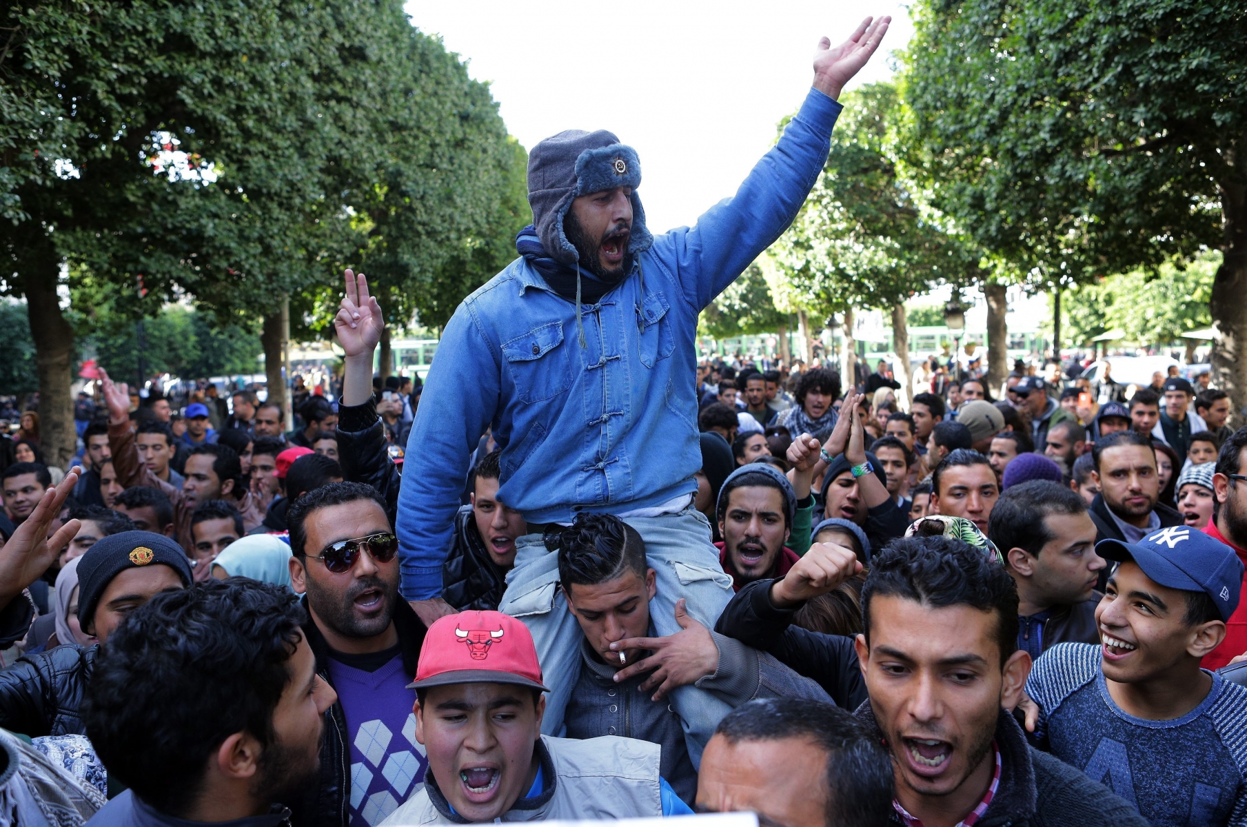 epa05116258 Unemployed graduates shout slogans during a demonstration urging the government to provide them with job opportunities, in Tunis, Tunisia, 21 January 2016. Reports state one policeman was killed in clashes between security forces and protesters demanding jobs in Tunisia's western-central province of Kasserine, a security official said on 21 January. The protests in Kasserine started at the weekend after an unemployed young man reportedly suffered a deadly electric shock when he climbed a power pole to protest a rejected job application.  EPA/MOHAMED MESSARA TUNISIA UNEMPLOYED GRADUATES PROTEST