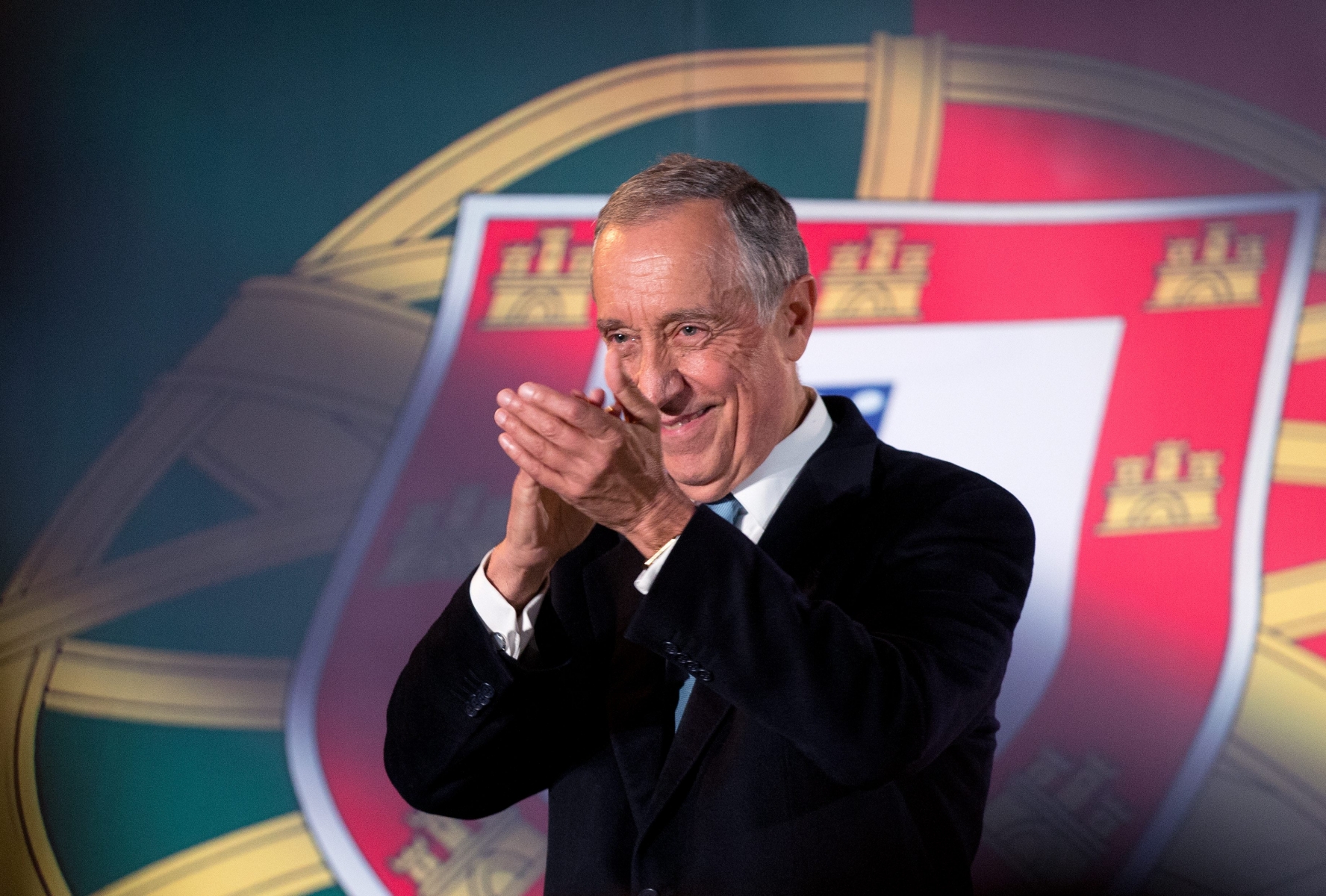 Marcelo Rebelo de Sousa applauds after addressing supporters at Lisbon's Santa Apolonia train station during his presidential election campaign Wednesday, Jan. 20 2016. Polls suggest that the center-right candidate Rebelo de Sousa could get more than 50 percent of votes against nine rivals in the Jan. 24 Portuguese presidential election. In Portugal the president has no executive power, which is held by the government, but is an influential voice. (AP Photo/Armando Franca)