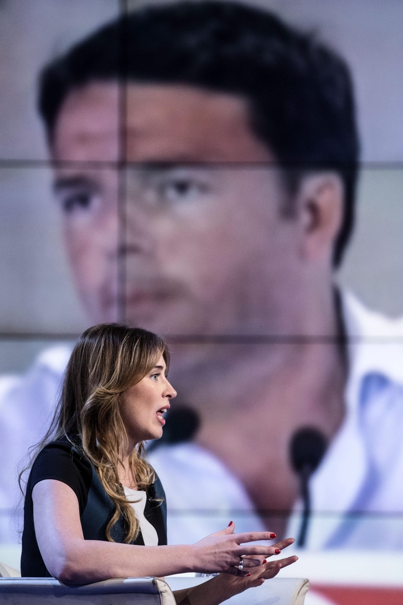 epa05245345 Italian Minister for Reforms, Maria Elena Boschi, sits in front of a screen showing Italian Prime Minister Matteo Renzi, during the Italian RAI Tv program 'Porta a porta', conducted by journalist Bruno Vespa, in Rome, Italy, 05 April 2016.  EPA/ANGELO CARCONI ITALY RAI TV BOSCHI