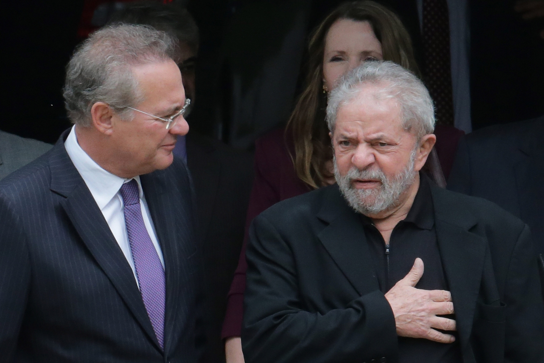 Brazils former President Luiz Inacio Lula da Silva, right, and Senate President Renan Calheiros, chat at the end of a breakfast with senators of the government's allied base, in Brasilia, Brazil, Wednesday, March 9, 2016. (AP Photo/Eraldo Peres) Brazil Lula