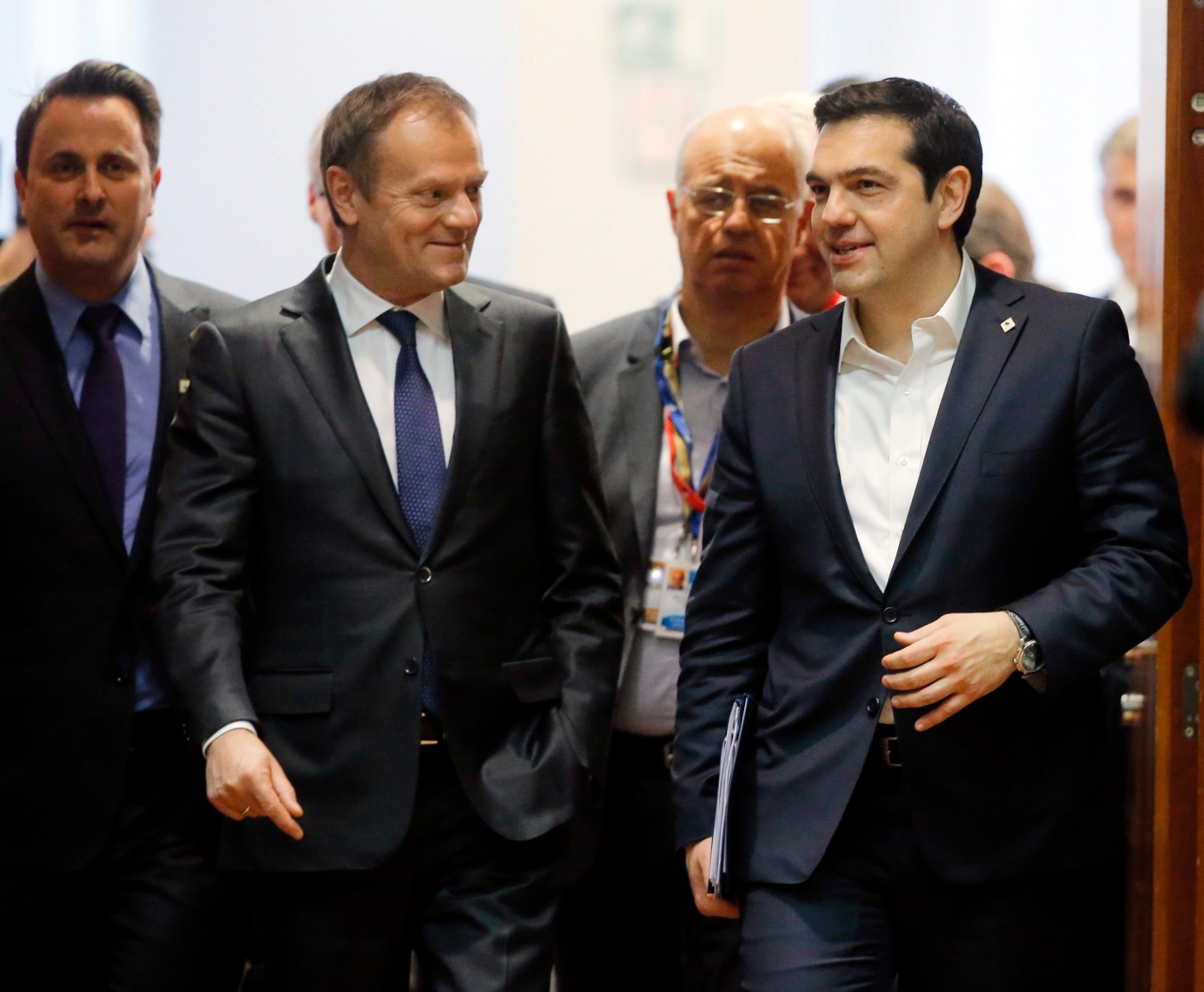 epa05216563 EU Council President Donald Tusk (L) and Greek Prime Minister Alexis Tsipras (R) arrive on the first day of a two-days European Union leaders summit in Brussels, Belgium, 17 March 2016. Others are not identified. EU leaders on 17 and 18 March are to discuss a deal with Turkey that is aimed to tackle the migration crisis and curb migration into the bloc.  EPA/OLIVIER HOSLET BELGIUM EU SUMMIT
