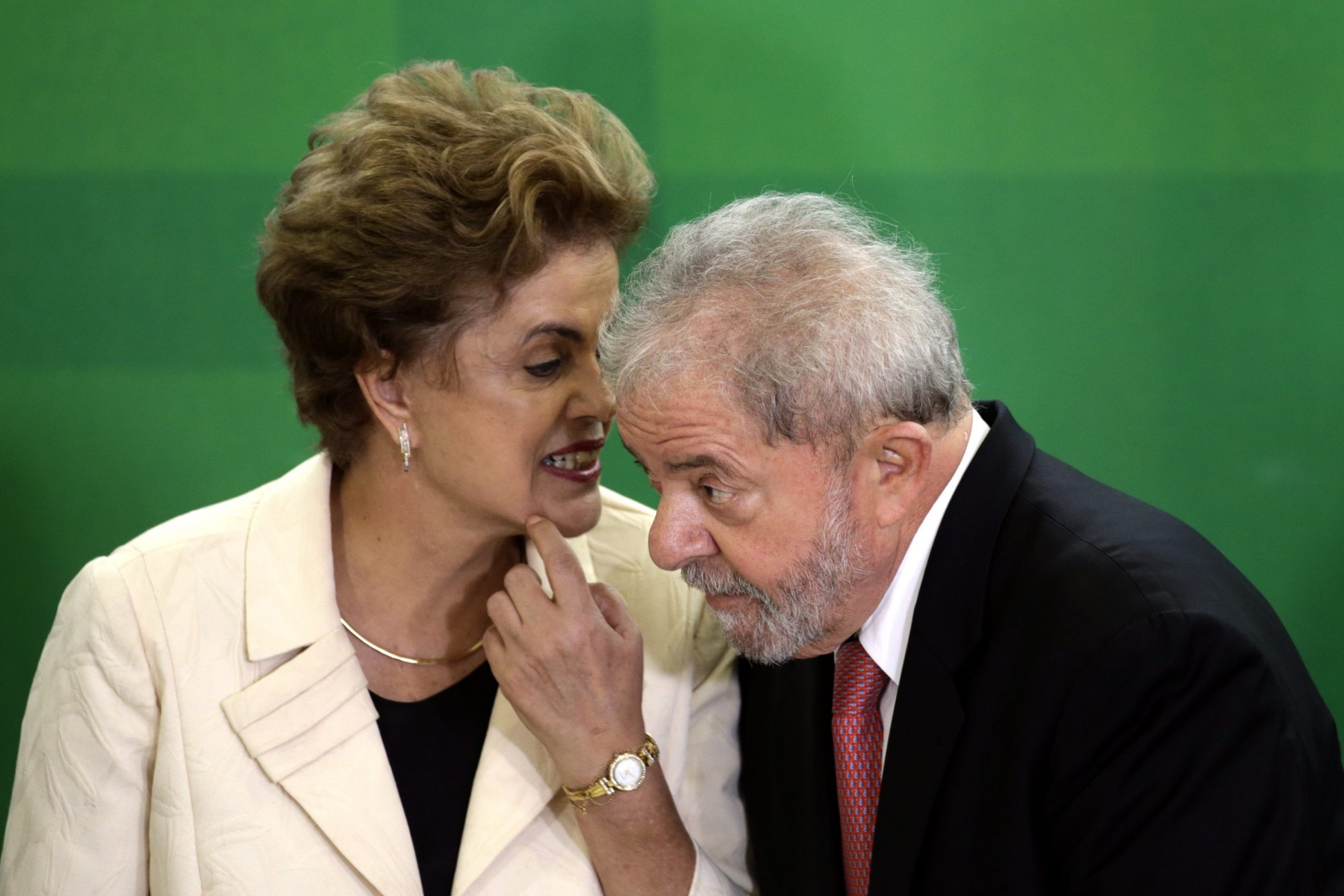 epa05216371 President of Brazil, Dilma Rousseff (L) with her predecessor, Former President of Brazil, Luiz Inacio Lula da Silva (R), as she swears him in as the new Chief of Staff Minister, in a ceremony held an Planalto Palace in Brasilia, Brazil, 17 March 2016. Silva now has legal immunity in a corruption investigation, which has caused protests across several cities in Brazil. Rousseff said 'The current circumstances give me the great opportunity to bring the Government to the greatest political leader of this country' at the ceremony, which was attended by hundreds of parliamentarians, both pro-Government and opposition, and members of social movements.  EPA/FERNANDO BIZERRA JR BRAZIL GOVERNMENT CORRUPTION