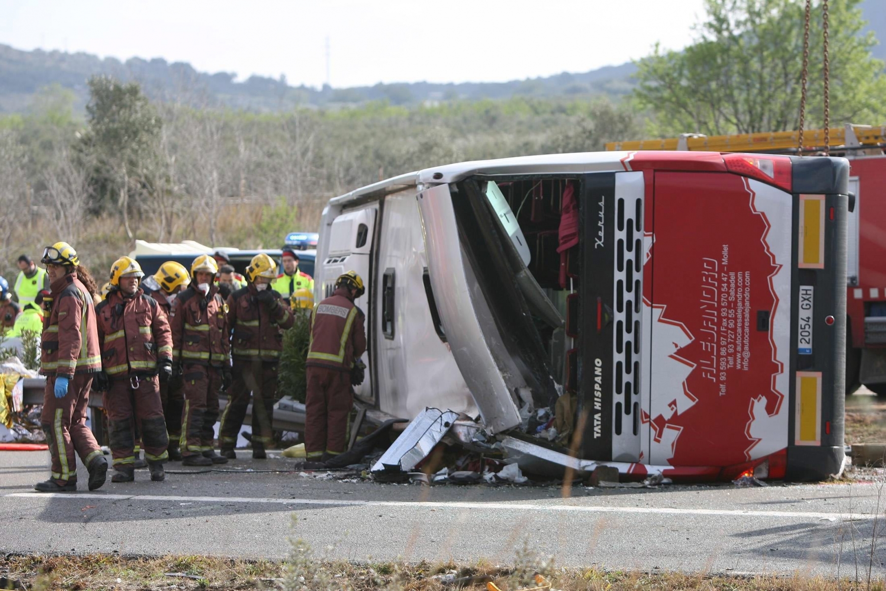 epa05222061 Firemen work at the site of a coach crash that has left at least 14 students dead at the AP-7 motorway in Freginals, in the province of Tarragona, northeastern Spain, 20 March 2016. The coach carrying dozens of Erasmus students collided with a car and overturned. The students from several different countries were heading to Barcelona after attending Las Fallas Festival in Valencia, eastern Spain.  EPA/JAUME SELLART