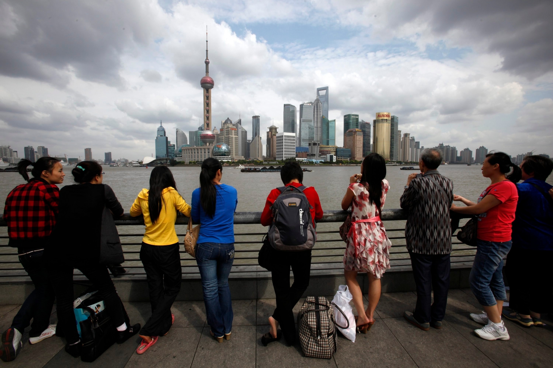 Tourists look at high-rising buildings in Pudong new develop zone in Shanghai, China, Monday, Sept. 19, 2011. (AP Photo/Eugene Hoshiko) China Daily Life