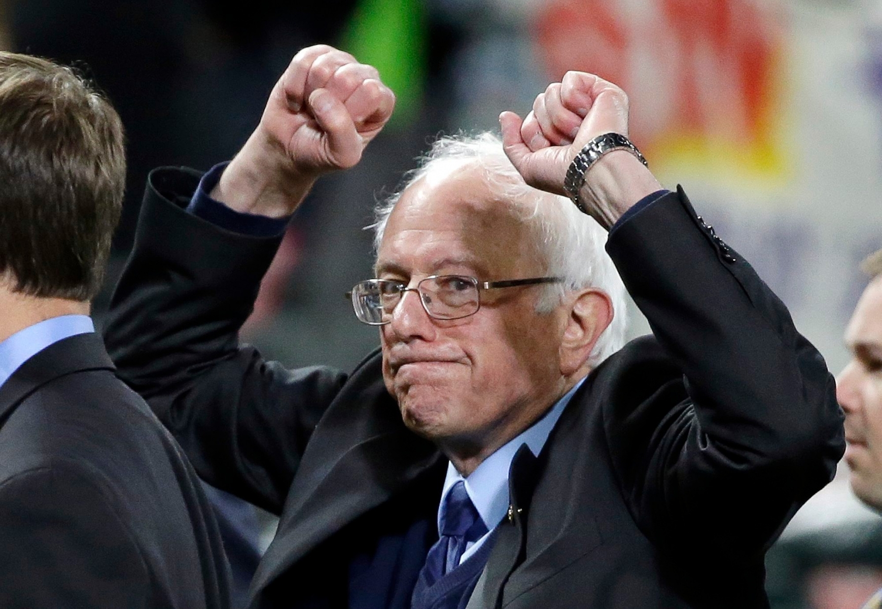 Democratic presidential candidate Sen. Bernie Sanders, I-Vt., pumps his fists as he leaves the field after speaking at a rally Friday, March 25, 2016, in Seattle. (AP Photo/Elaine Thompson) DEM 2016 Sanders