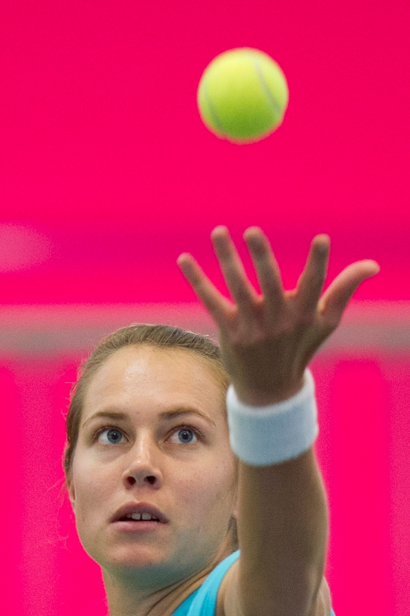 Swiss Fed Cup tennis player Stefanie Voegele plays a ball during a training session in the Sports Center Arena in Yverdon, Switzerland, Wednesday, April 18, 2012. Switzerland faces Belarus in the World Group II, Play-off Round. (KEYSTONE/Jean-Christophe Bott) SWITZERLAND TENNIS FED CUP CHE BLR