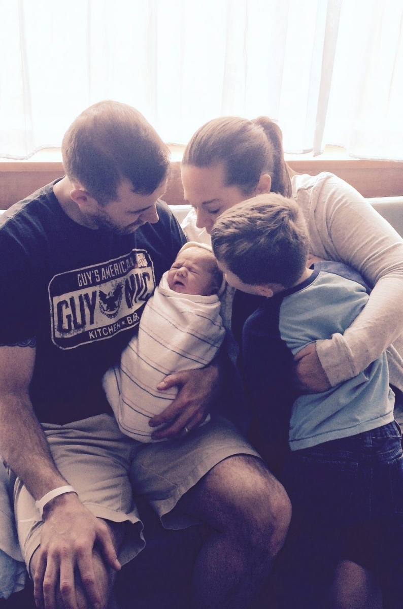 This photo provided by Dic Donohue shows retired MBTA police officer Donohue and his family with their new son, Connor, at Mount Auburn Hospital on Friday, April 22, 2016, in Cambridge, Mass. The baby was born Friday, three years to the day after Donohue emerged from a coma following his wounding in the pursuit of the Boston Marathon bombing suspects. Donohue announced the birth on Twitter.  (Dic Donohue via AP) Boston Marathon Injured Officer