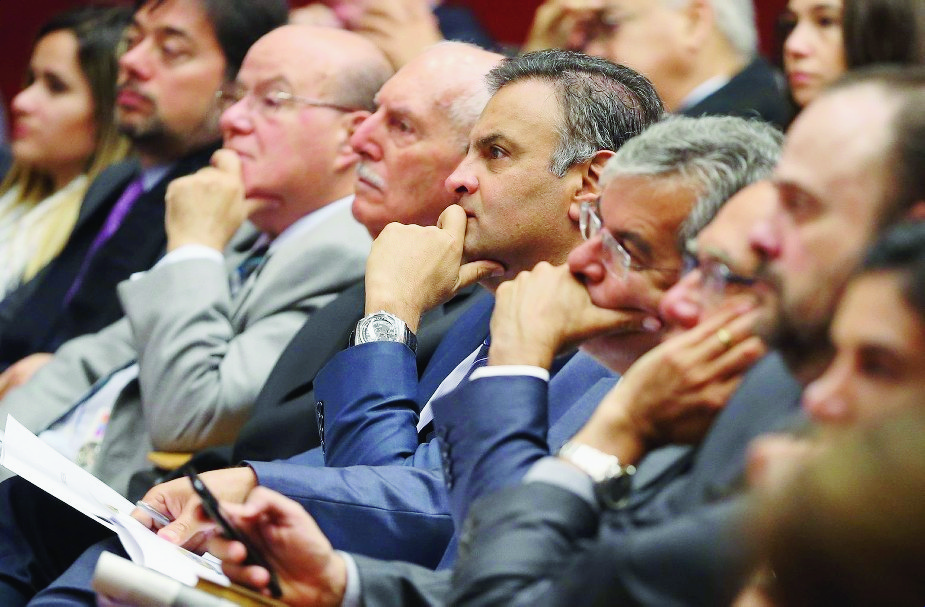 FILE - In this March 31 2016 file photo, Brazilian Senator Aecio Neves, center, listens during at a legal conference in Lisbon, Portugual. Neves, the Brazilian opposition PSDB partyís 2014 presidential candidate who narrowly lost to the now-embattled incumbent President Dilma Rousseff, was named among many top officials to be investigated for corruption, authorized by Brazil's attorney general according to Brazilian news reports on Monday, May 2, 2016.  (AP Photo/Armando Franca, File) Portugal Brazil Crisis