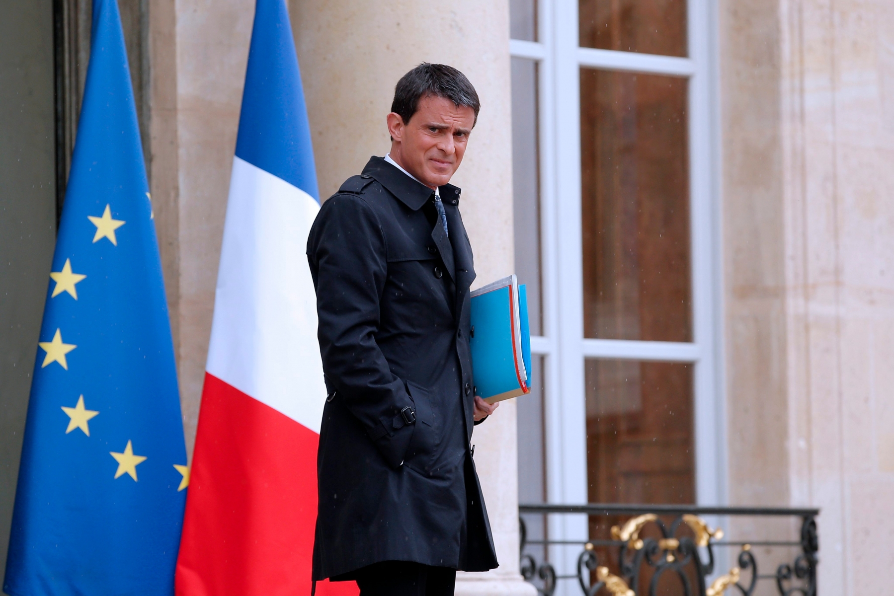 epa05297801 French Prime Minister Manuel Valls leaves the Elysee Palace following an extraordinary Cabinet Meeting in Paris, France, 10 May 2016. The French Council of Ministers has authorized the French Prime Minister to use the 49.3 article of the French constitution to pass the controversial labor reform law at Parliament. Article 49.3 of the French constitution authorizes the government to pass a bill without putting it for a vote at the French Parliament afterwards and it engages the responsibility of the government if ever the 49.3 is censored and forced to be voted and denied.  EPA/YOAN VALAT FRANCE LABOR