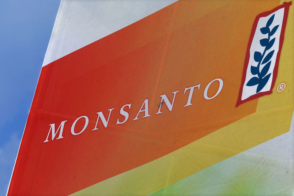FILE - This Aug. 31, 2015 file photo shows the Monsanto logo seen at the Farm Progress Show in Decatur, Ill. German drug and chemicals company Bayer AG says it has made a  billion offer to buy U.S.-based crops and seeds specialist Monsanto Company. Bayer said Monday, May 23, 2016 that the all-cash offer values Monsanto shares at  each. (AP Photo/Seth Perlman, File)