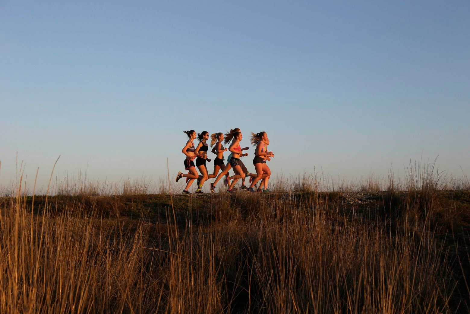Joggers form a group along a trail as the sun sets at the Baylands Nature Preserve Tuesday, Jan. 6, 2015, in Palo Alto, Calif. Temperatures in the area for Tuesday ranged from the mid 40s to the upper 60s Fahrenheit. (AP Photo/Marcio Jose Sanchez) California Daily Life