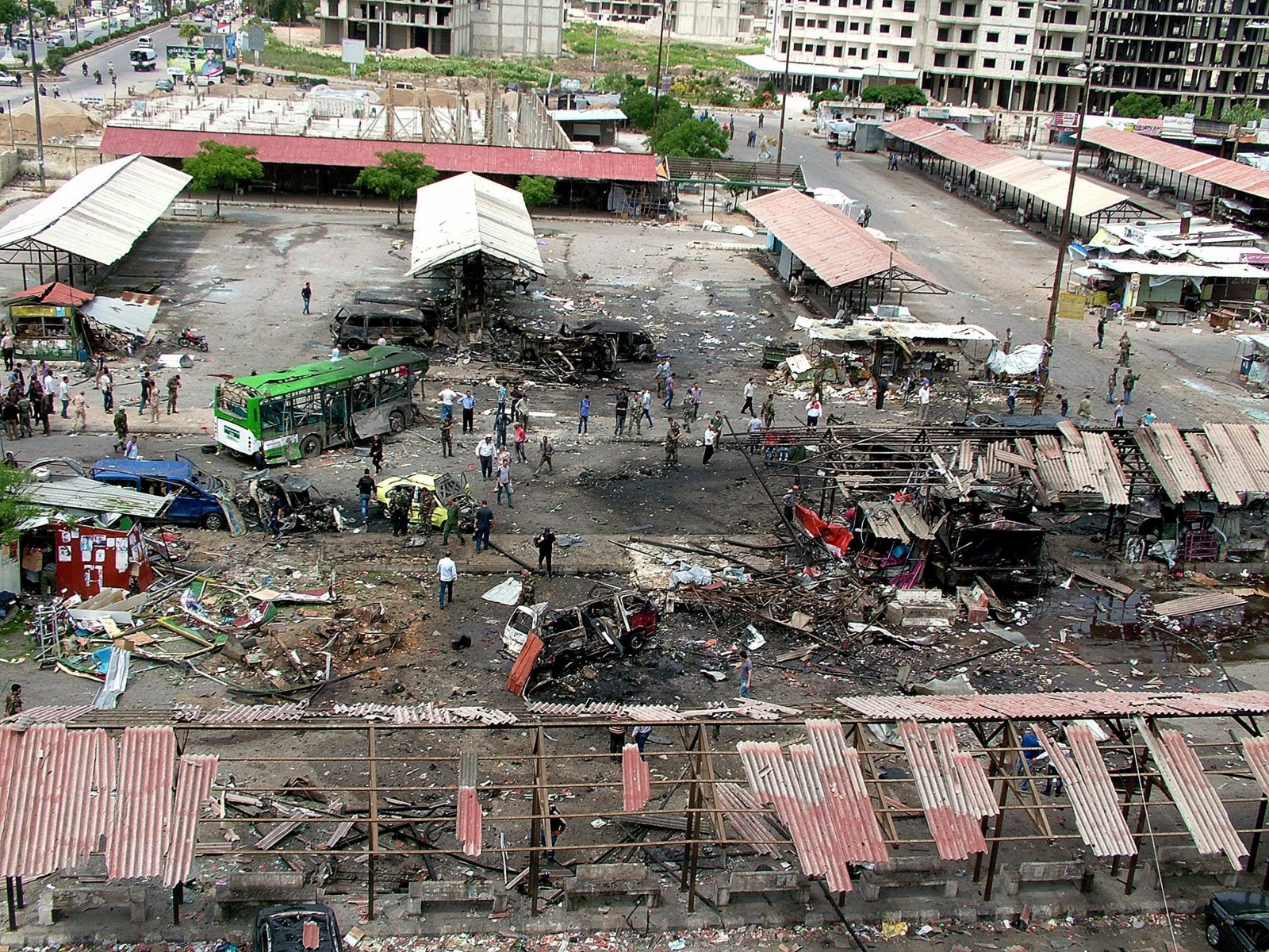 epa05324992 A handout photograph released by the official Syrian Arab News Agency (SANA) shows people inspecting the damage at the site of car bombing in a bus station in the Jableh city, Lattakia province, Syria, 23 May 2016. According to SANA, at least 78 people were killed and scores injured in a series of bombings in the coastal cities of Tartous  and Jableh.  EPA/SANA HANDOUT  HANDOUT EDITORIAL USE ONLY/NO SALES SYRIA UNREST JABLEH BLAST