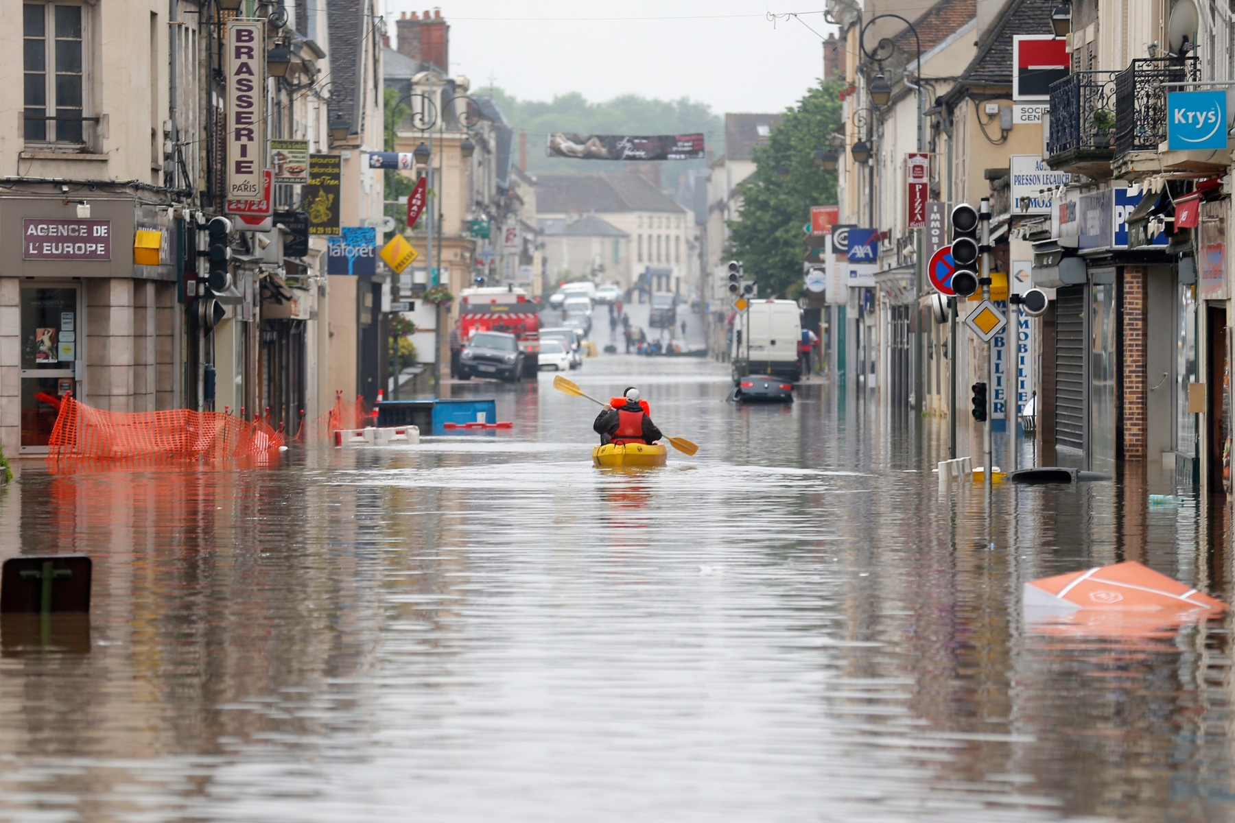 Residents use a canoe to evacuate in downtown Nemours, 50 miles south of Paris, Thursday, June 2, 2016. Floods inundating parts of France and Germany have left five people reported dead and thousands trapped in homes or cars, as rivers have broken their banks from Paris to Bavaria. (AP Photo/Francois Mori) France Floods