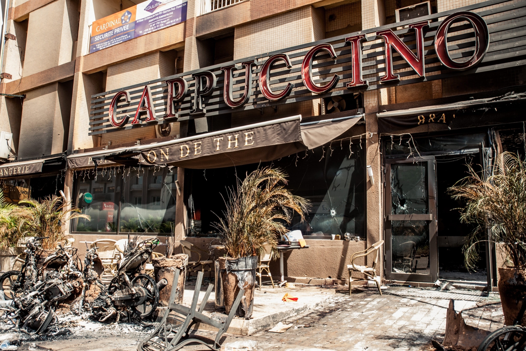 epa05109170 A general view of damaged outside of the Cappuccino bar opposite the Splendid Hotel in Ouagadougou, Burkina Faso 18 January 2016. According to media reports at least 28 people from 18 nationalities were killed after Islamist militants attacked The Splendid Hotel frequented by many westeners in Burkina Faso the evening of 15 January 2016. A joint operation by French and Burkina Faso forces freed many hostages on 16 January 2016. Al-Qaeda in the Islamic Maghreb (AQIM) claimed responsibility.  EPA/WOUTER ELSEN BURKINA FASO SPLENDID HOTEL ATTACK AFTERMATH