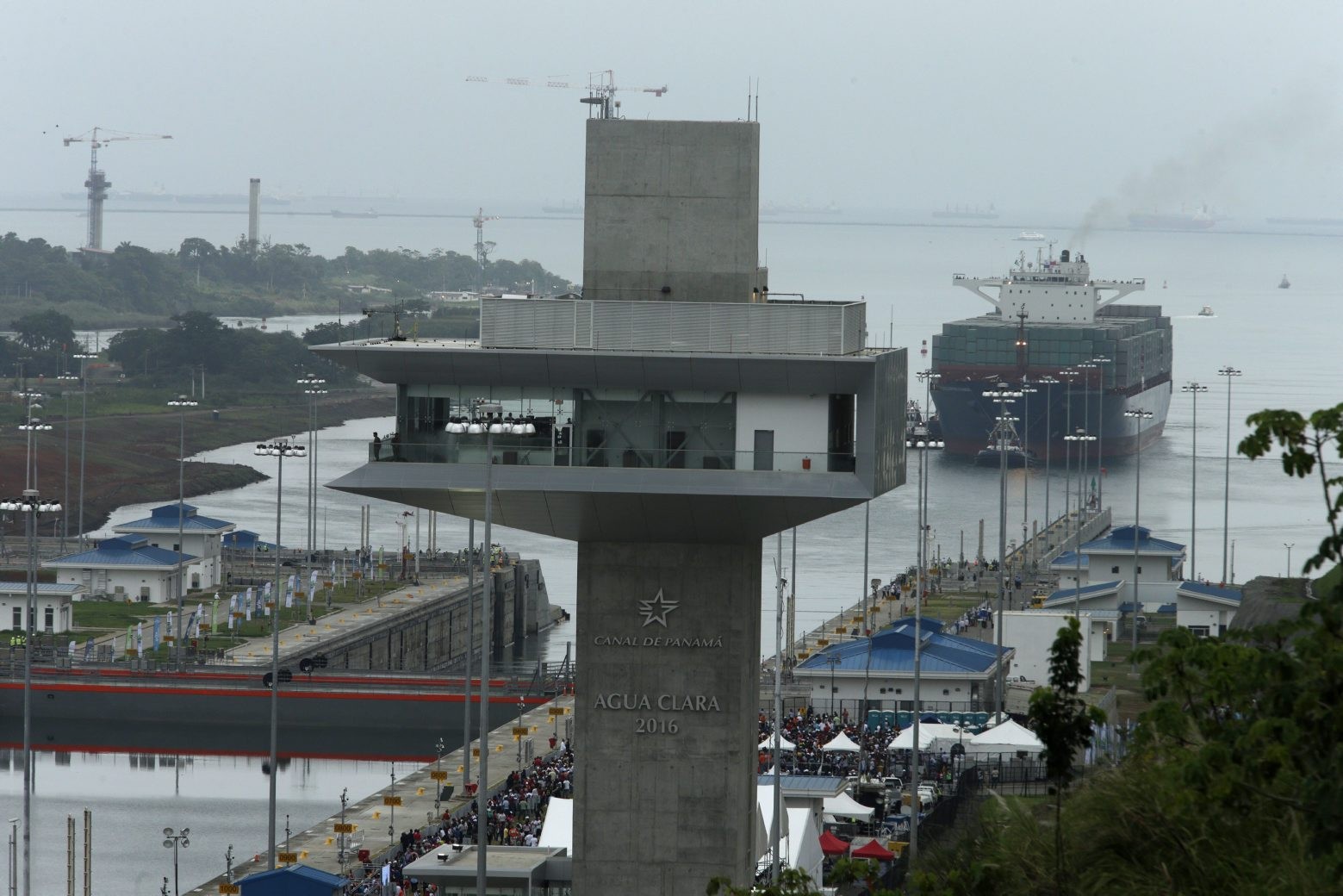 The Neopanamax cargo ship, Cosco Shipping Panama, approaches the new Agua Clara locks, part of the Panama Canal expansion project, near the port city of Colon, Panama, Sunday June 26, 2016. The ship carrying more than 9,000 containers entered the newly expanded locks that will double the Panama Canal's capacity in a multibillion-dollar bet on a bright economic future despite tough times for international shipping. (AP Photo/ Arnulfo Franco) Panama Canal Expansion