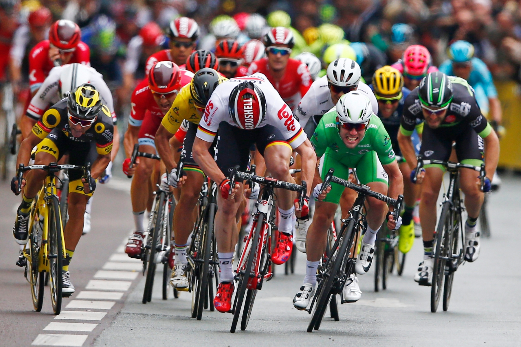 Britain's Mark Cavendish, wearing the best sprinter's green jersey, sprints with Germany's Andre Greipel, center in white, to win the third stage of the Tour de France cycling race over 223.5 kilometers (138.6 miles) with start in Granville and finish in Angers, France, Monday, July 4, 2016. (AP Photo/Peter Dejong) France Cycling Tour de France