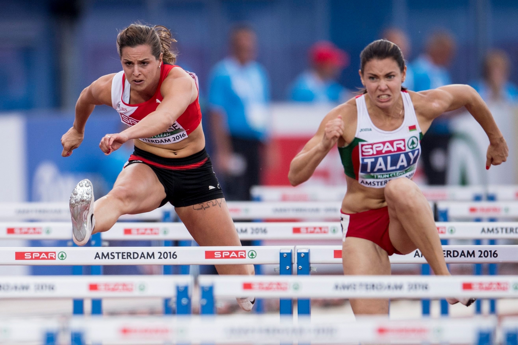 Swiss athlete Clelia Rard-Reuse, left, jumps next to Alina Talay of Bulgaria, right, during the women's 100m hurdles final at the 2016 European Athletics Championships in Amsterdam, Netherlands, Thursday, 07 July 2016. The 2016 European Athletics Championships in Amsterdam, Netherlands, runs from 06 to 10 July 2016. (KEYSTONE/Ennio Leanza) LEICHTATHLETIK EM 2016 AMSTERDAM