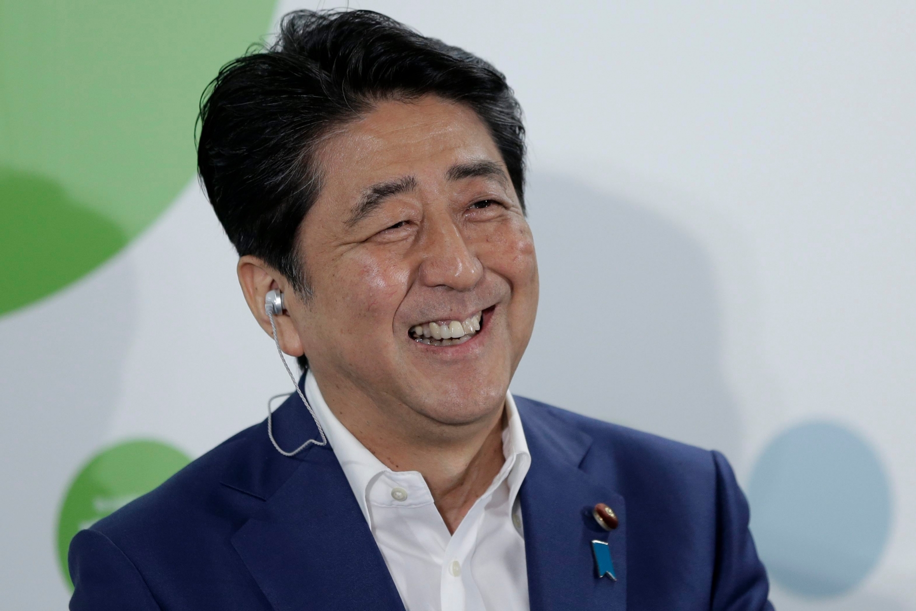 epa05418631 Japanese Prime Minister and the ruling Liberal Democratic Party (LDP) President Shinzo Abe smiles during a media interview after putting red rose marks on the names of the party's victorious candidates in the Upper House election at the LDP headquarters in Tokyo, Japan, 10 July 2016. The Upper House election was held on 10 July, and Abe's Liberal Democratic Party and its coalition partner Komeito won a majority in the election.  EPA/KIYOSHI OTA JAPAN ELECTIONS PARTIES