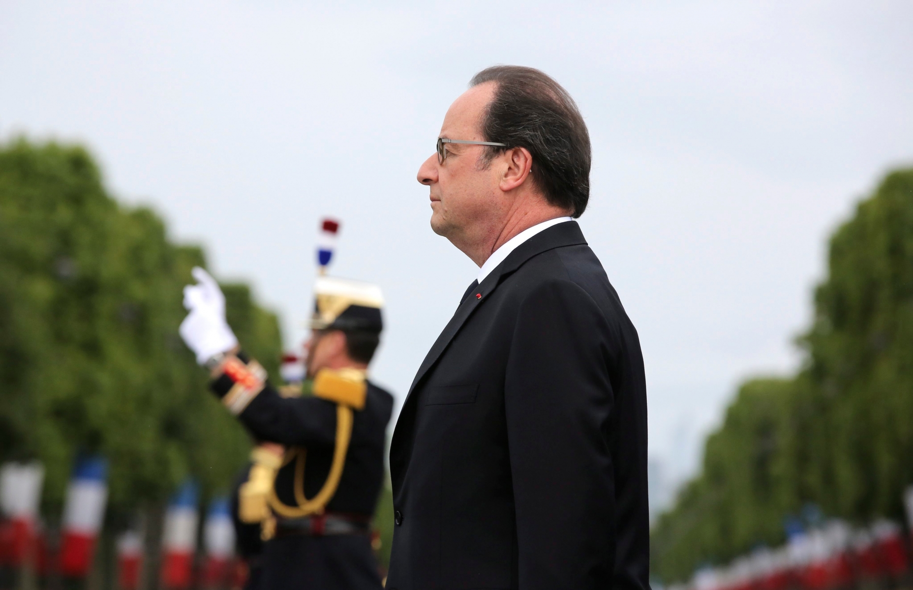 epa05424049 French President Francois Hollande reviews the troops, during the Bastille Day Parade on the Champs Elysees avenue in Paris, France, 14 July 2016. France holds annual Bastille Day military parade with troops from Australia and New Zealand as special guests among the 3,000 soldiers who will march up the Champs Elysees avenue. They will be accompanied by 200 vehicles with 85 aircraft flying overhead.  EPA/THIBAULT CAMUS / POOL MAXPPP OUT FRANCE BASTILLE DAY MILITARY PARADE