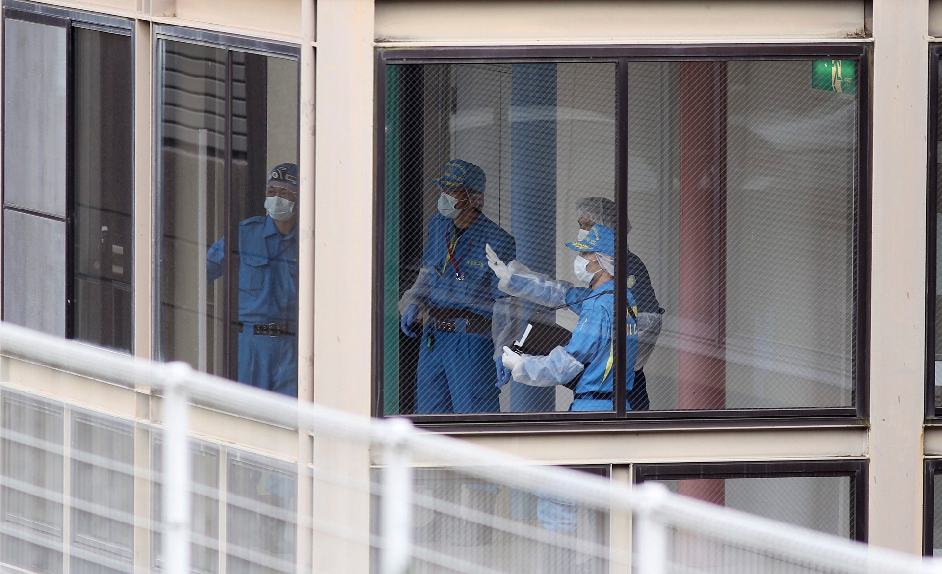 Police investigators work at the Tsukui Yamayuri-en, a facility for the disabled where a number of people were killed and dozens injured in a knife attack in Sagamihara, outside Tokyo Tuesday, July 26, 2016. Police said they responded to a call at about 2:30 a.m. from an employee saying something horrible was happening at the facility in the city of Sagamihara, 50 kilometers (30 miles) west of Tokyo. A man turned himself in at a police station about two hours later, police said.(AP Photo/Eugene Hoshiko) Japan Knife Attack