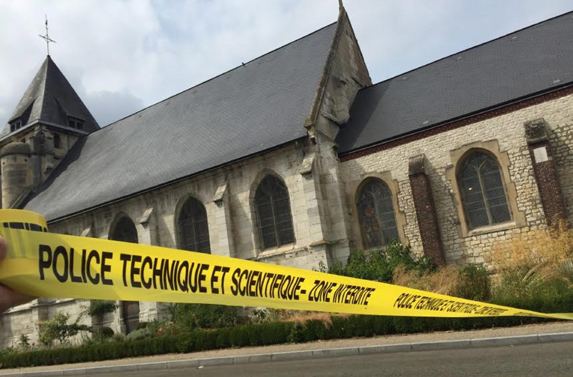 epa05442064 A handout picture provided by Police Nationale on 26 July 2016 shows police cordoning off a church where a hostage incident occured in Saint-Etienne-du-Rouvray, near Rouen, France, 26 July 2016. According to reports, two hostage takers were killed by the police after they took hostages at a church in Saint Etienne du Douvray. One of the hostages, a priest was killed by one of the perpetrators.  EPA/POLICE NATIONALE / HANDOUT BEST QUALITY AVAILABLE HANDOUT EDITORIAL USE ONLY/NO SALES FRANCE CRIME CHURCH ATTACK