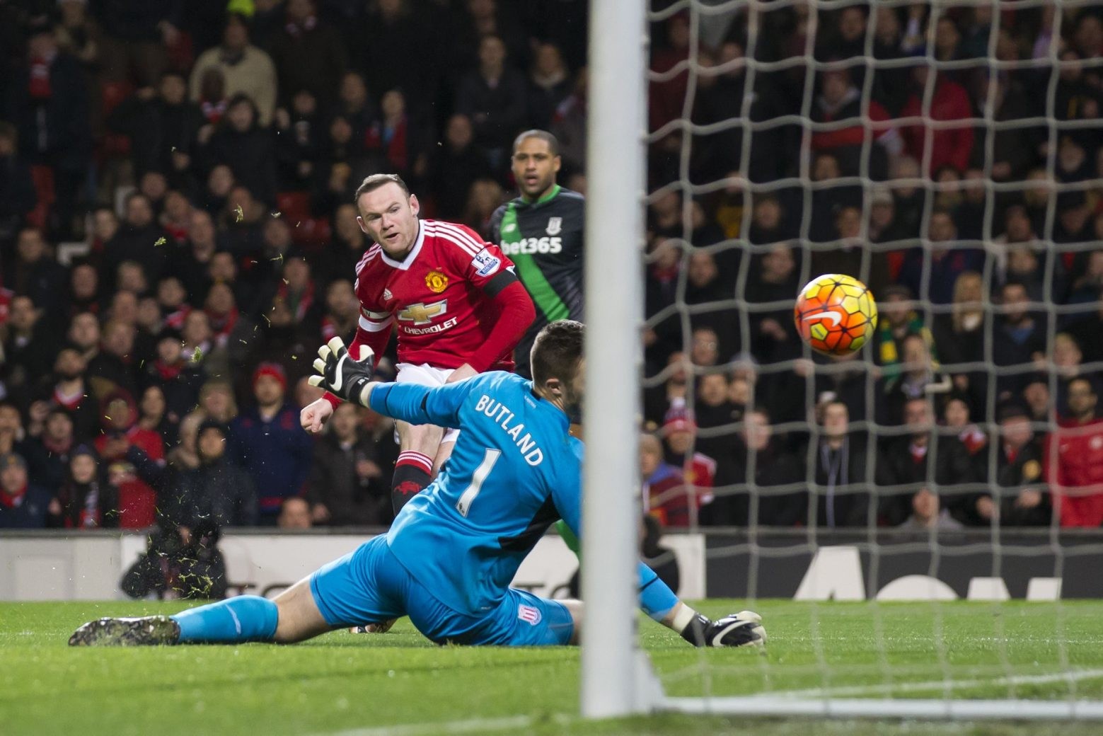 Manchester United's Wayne Rooney, top left, places the balll in the net past Stoke's goalkeeper Jack Butland only for his goal to be disallowed during the English Premier League soccer match between Manchester United and Stoke at Old Trafford Stadium, Manchester, England, Tuesday, Feb. 2, 2016. (AP Photo/Jon Super) BRITAIN SOCCER PREMIER LEAGUE