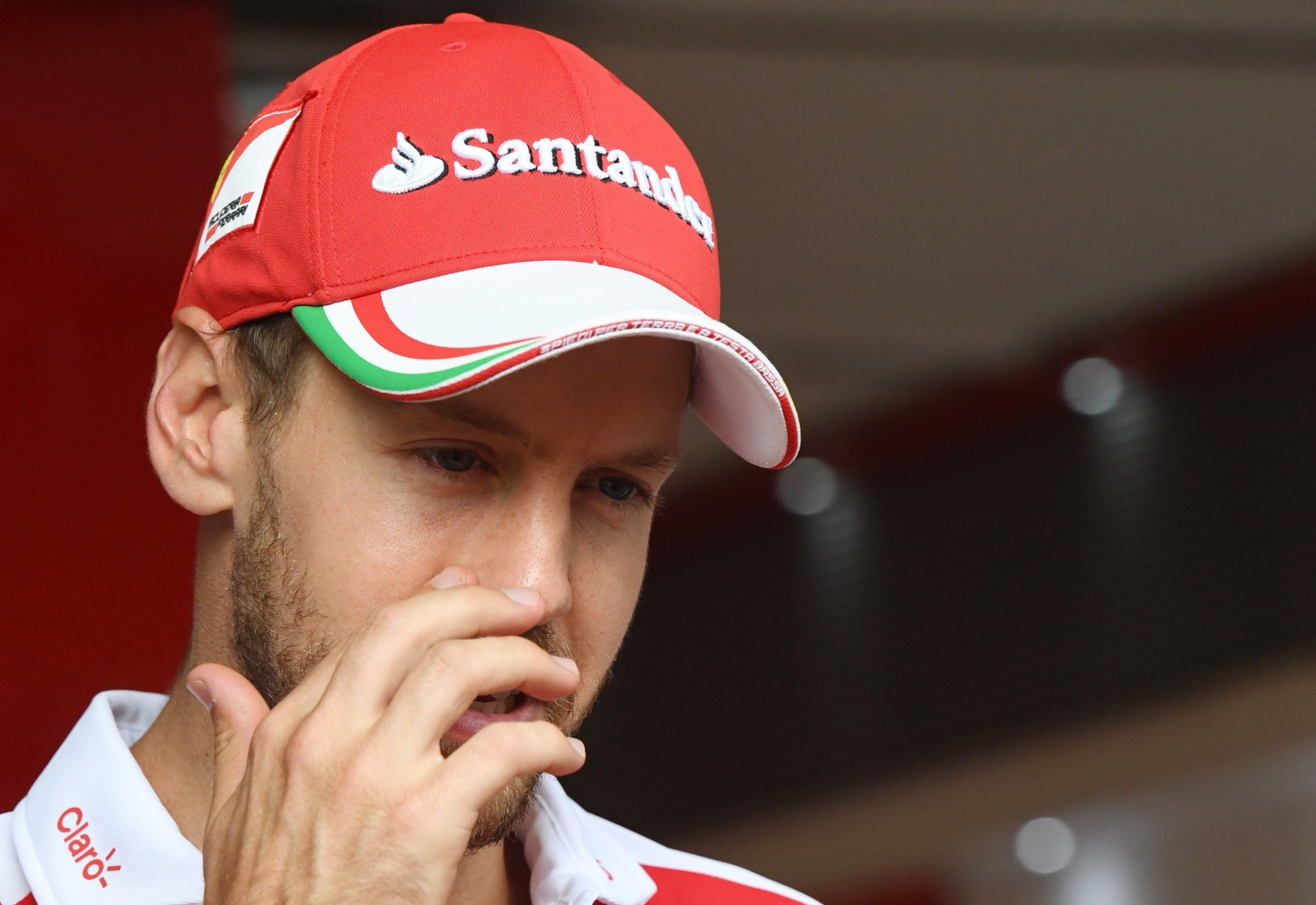 epa05450077 German driver Sebastian Vettel from Team Scuderia Ferrari in the drivers area after placing fifth in the the German Formula Grand Prix in the Hockenheimring in Hockenheim, Germany, 31 July 2016.  EPA/ULI DECK GERMANY FORMULA ONE GRAND PRIX