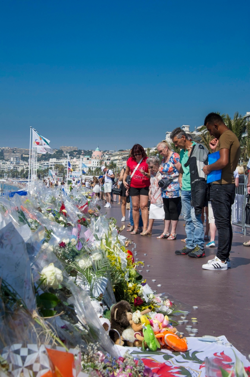 epa05432149 People gather at the new area for floral tributes on the 'Promenade des Anglais in the French riviera city of Nice, France, 19 July 2016, after deadly attack on Bastille day 14 July 2016. Tunisian attacker Mohamed Lahouaiej-Bouhlel visited the Nice promenade with his rented truck on the two days before he rammed the vehicle into a crowd, killing 84, a source close to the investigation said Sunday.. Tunisian Mohamed Lahouaiej-Bouhlel, 31, smashed a 19-tonne truck into a packed crowd of people in the Riviera city celebrating Bastille Day -- France's national day.  EPA/OLIVIER ANRIGO FRANCE NICE TRUCK ATTACK