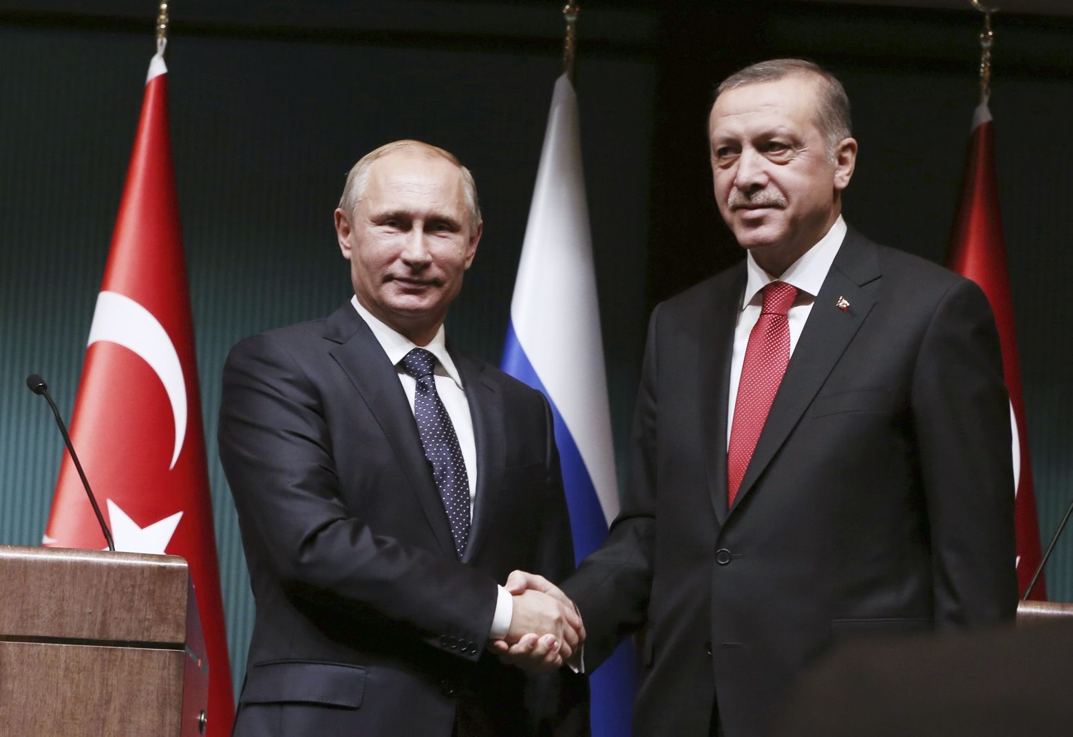 Russian President Vladimir Putin, left, and his Turkish counterpart Recep Tayyip Erdogan shake hands after a joint news conference at the new Presidential Palace in Ankara, Turkey, Monday, Dec. 1, 2014. Putin arrived in Turkey for a one-day visit and met with Erdogan at his huge new palace on once-protected farm land and forest in Ankara, becoming the second foreign dignitary after Pope Francis to be hosted at the lavish, 1,000-room complex. (AP Photo/Burhan Ozbilici) TUERKEI BESUCH RUSSLAND