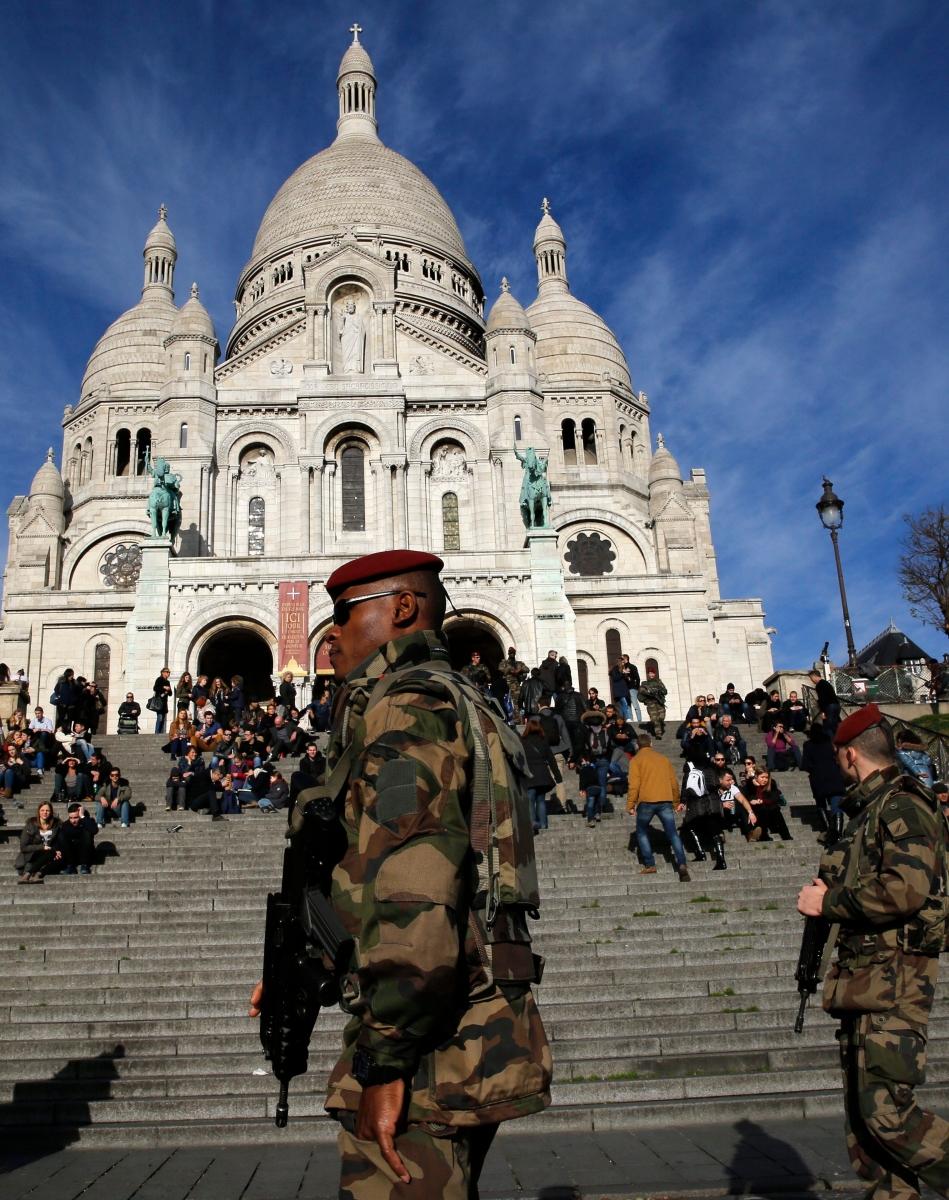 Soldiers patrol in front of the Sacre Coeur basilica, in Paris, Wednesday, Dec. 23, 2015. France's interior minister says the government will tighten security for churches around Christmas, amid continued concerns about potential extremist violence after deadly attacks last month. (AP Photo/Christophe Ena) France Holiday Security