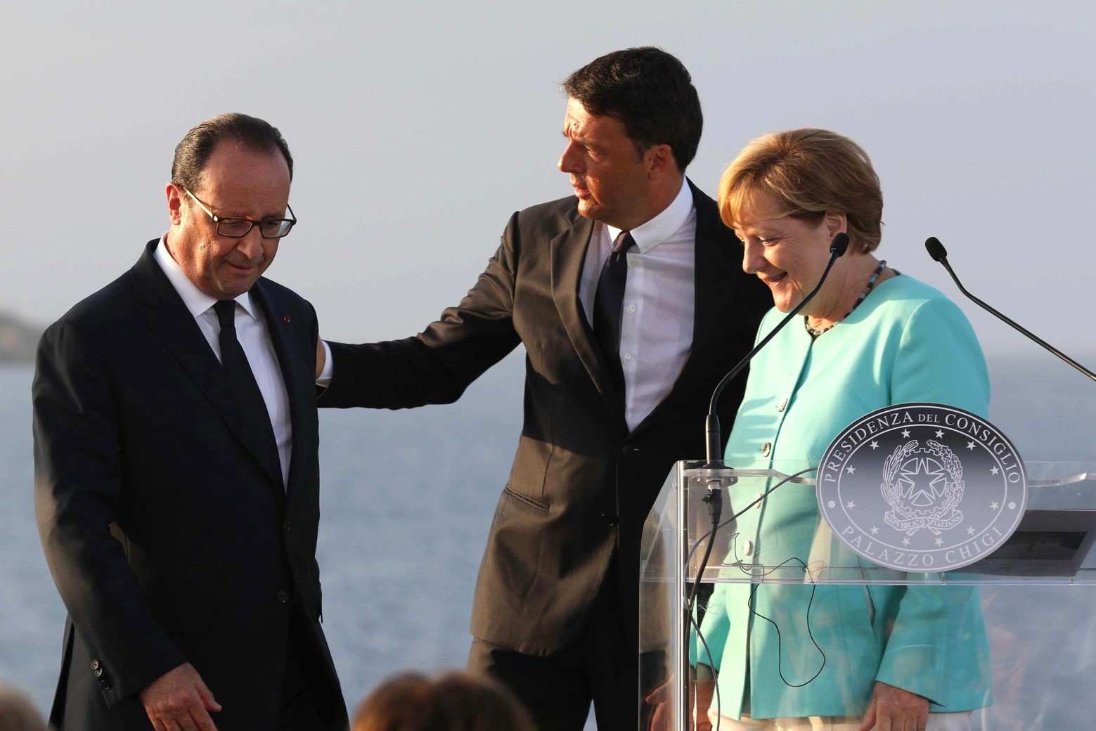 Italian Premier Matteo Renzi, center, stands between French President Francois Hollande, left, and German Chancellor Angela Merkel, on the deck of the Italian aircraft carrier Garibaldi off Ventotene island's shores, Italy, Monday, Aug. 22, 2016. The leaders of Italy, France and Germany headed Monday to one of the birthplaces of European unity in a symbolic bid to relaunch the European project following Britain's decision to leave the EU. (Cesare Abbate/ANSA via AP) Italy Brexit Summit
