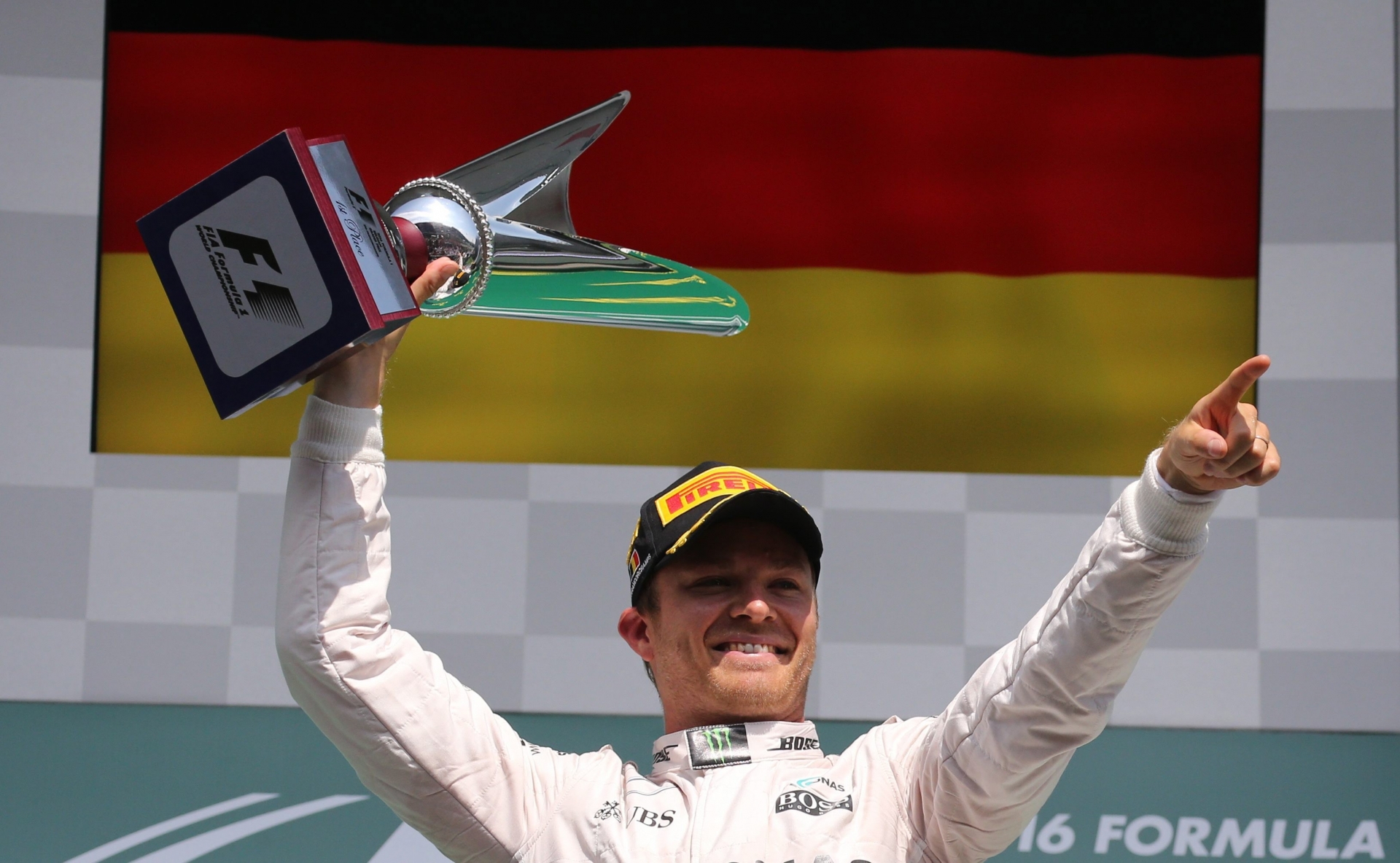 Mercedes driver Nico Rosberg of Germany celebrates by raising his trophy on the podium after winning the Belgian Formula One Grand Prix in Spa-Francorchamps, Belgium, Sunday, Aug. 28, 2016. (AP Photo/Olivier Matthys) Belgium F1 GP Auto Racing